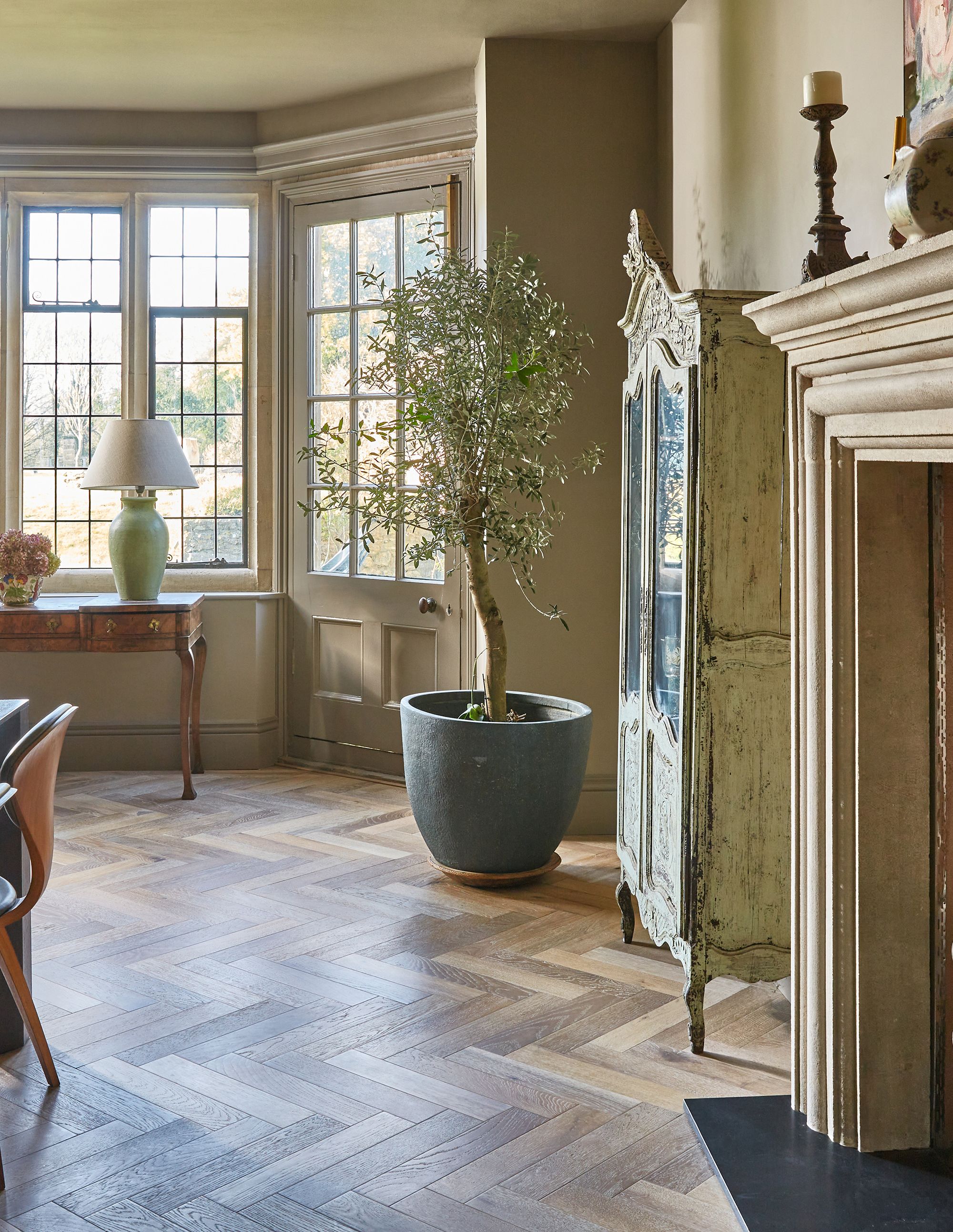 Herringbone patterned wood flooring in a dinning room setting 
