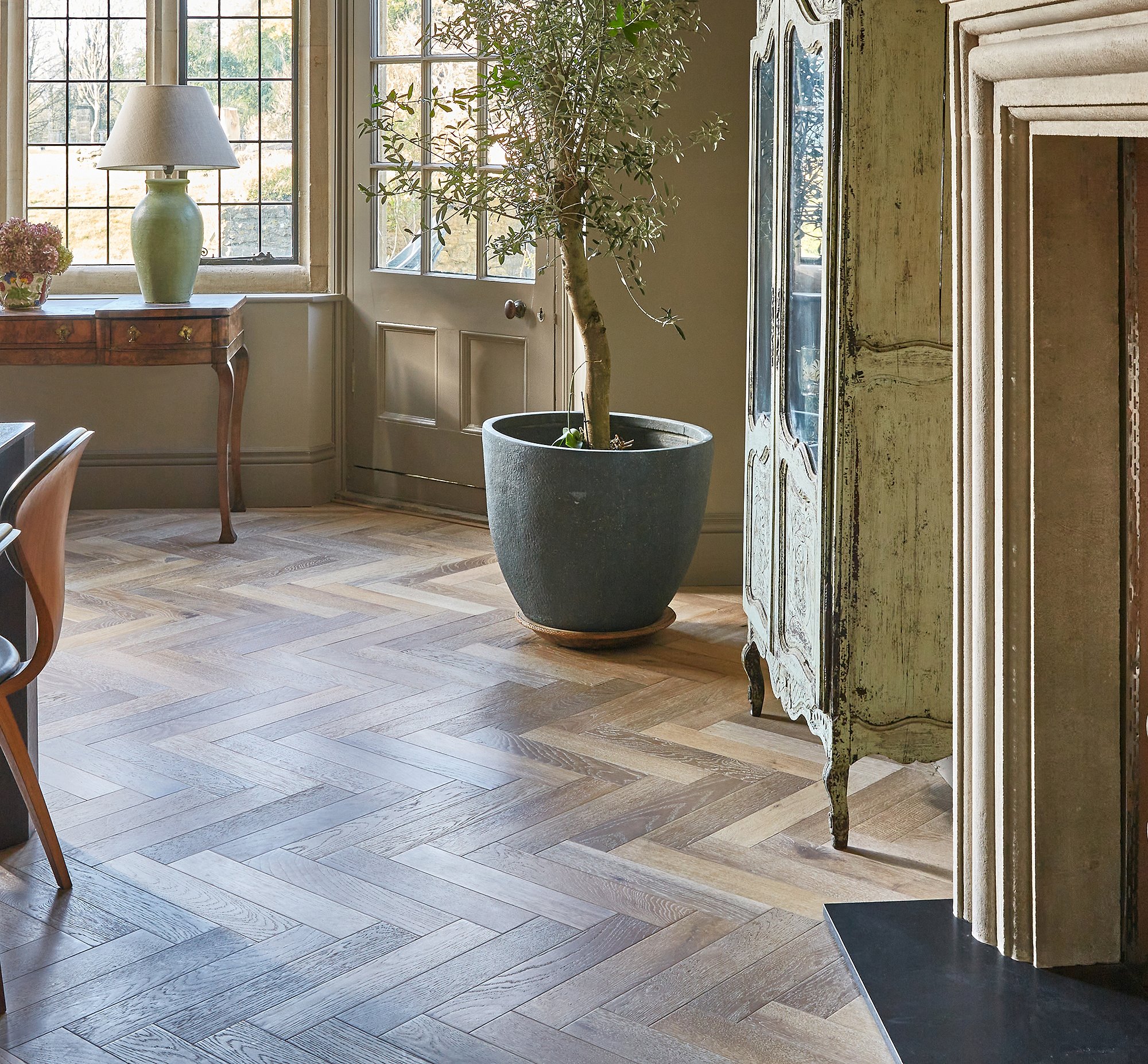 Herringbone patterned wood flooring in a dinning room setting