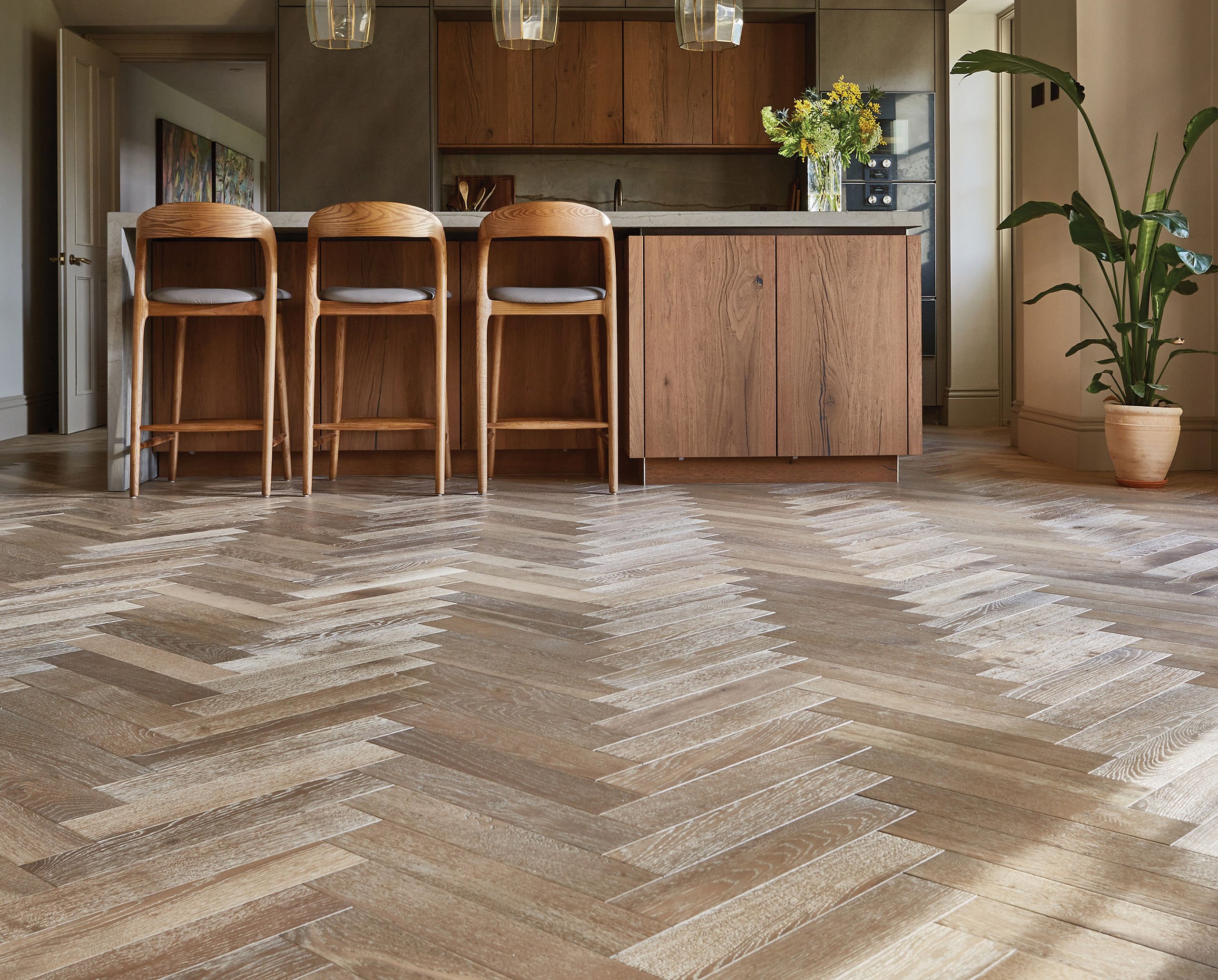 Herringbone wood flooring in a refined kitchen