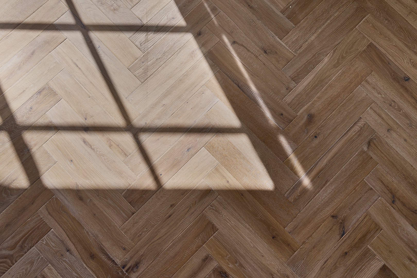 A calm interior with warm wood flooring in a herringbone pattern
