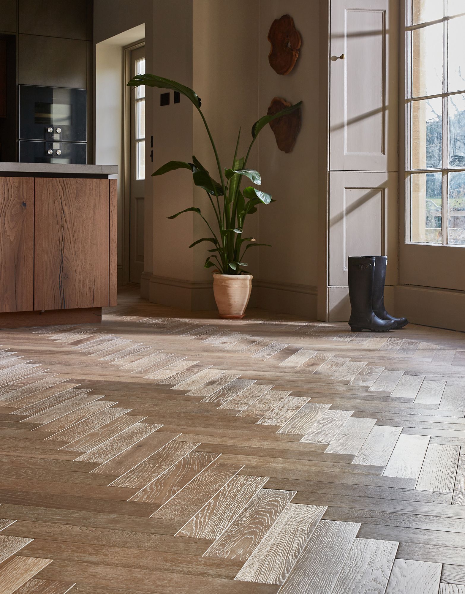 Close up of the herringbone wood flooring in a refined kitchen