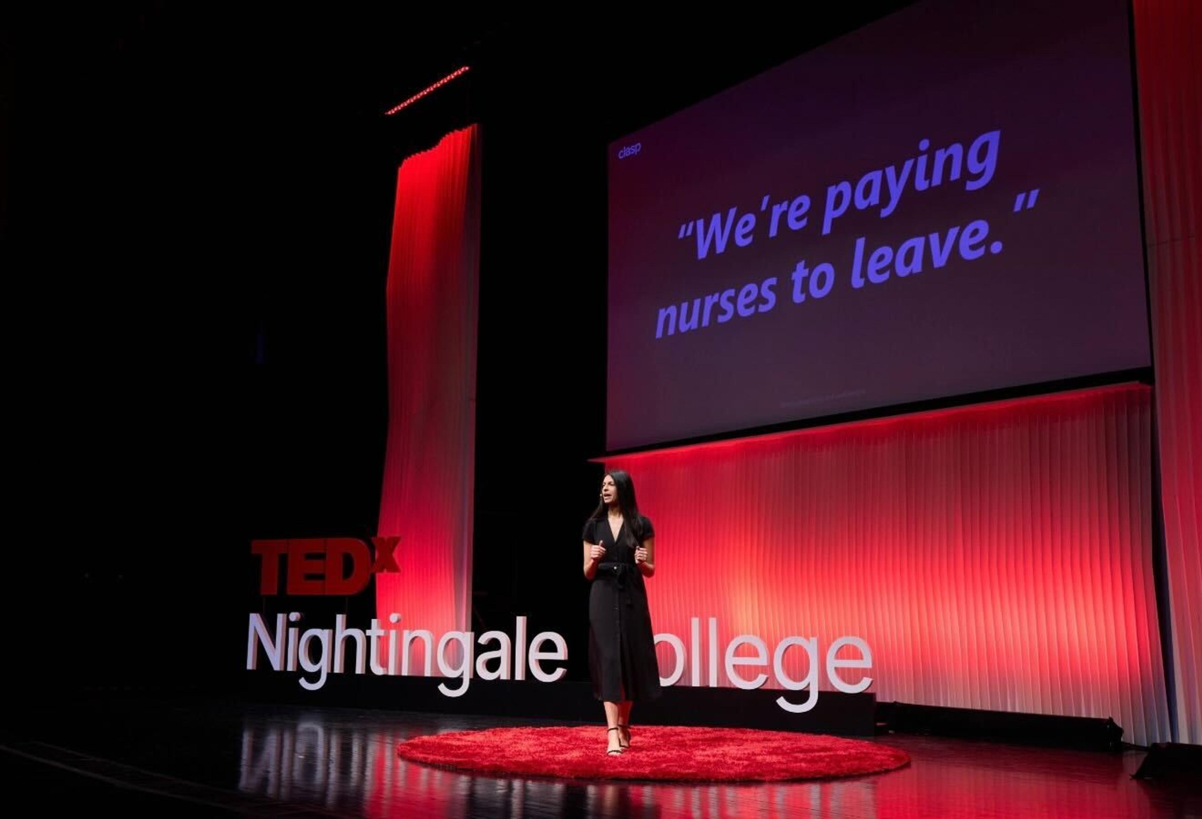 CEO and Founder of Clasp, Tess Michaels, delivers a TEDx talk about healthcare worker turnover, in front of a screen that reads "We're paying nurses to leave."