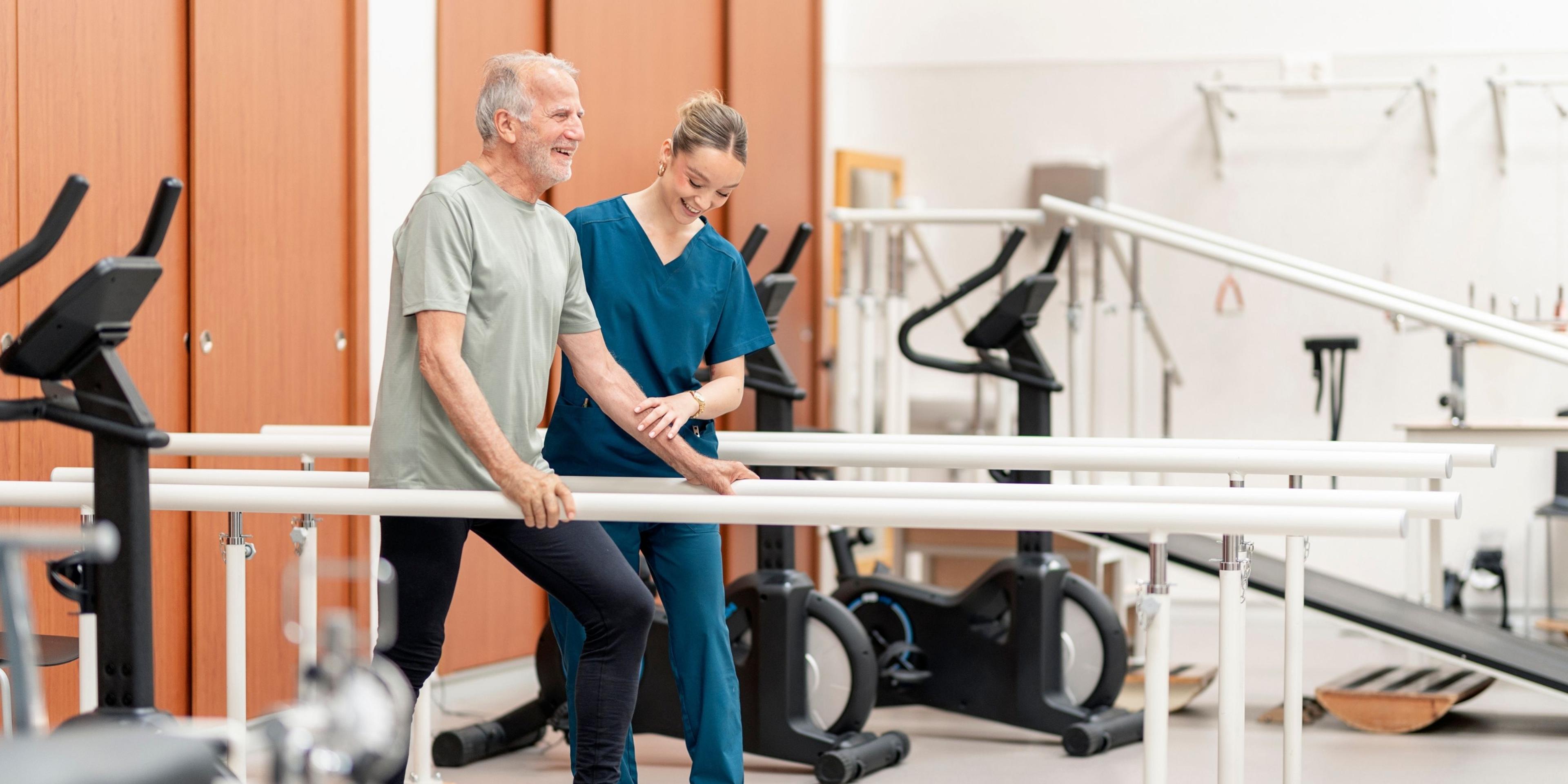 A HealthPro Heritage physical therapist helps a patient using a rolling walker in a bright clinic