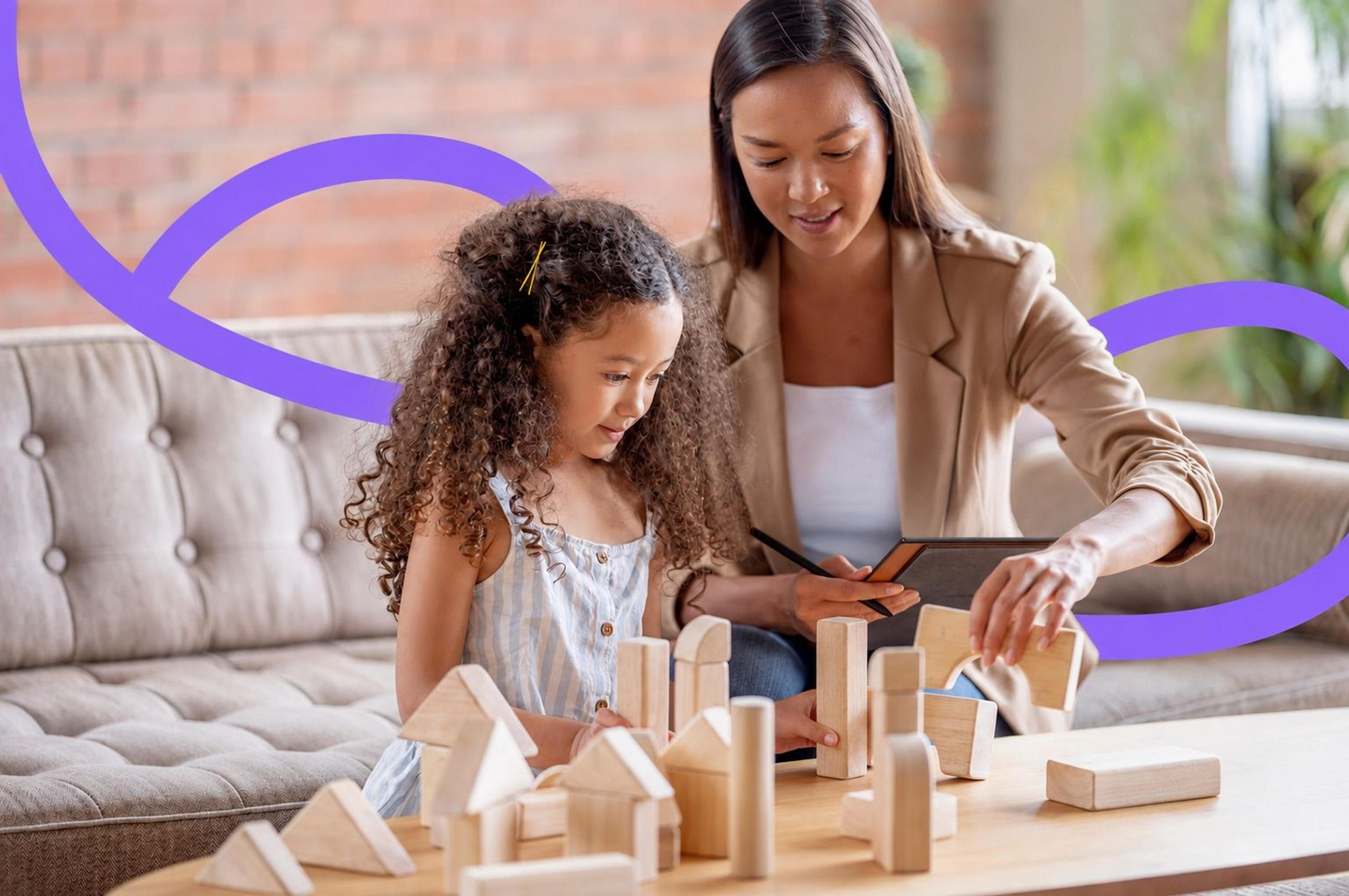 An occupational therapist guiding a young child through a play-based exercise with wooden blocks