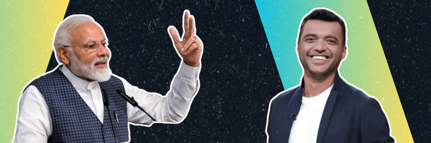 This image is a wide banner featuring two prominent figures against a split background. On the left side, Indian Prime Minister Narendra Modi, an older man with a beard, wearing a traditional Indian waistcoat over a kurta, is depicted speaking and making a peace sign with his hand. The background on his side is yellow-green. On the right side, Deepinder Goyal, the founder of Zomato, a younger man in a dark suit and white shirt, smiles broadly, with a black space-themed background behind him.