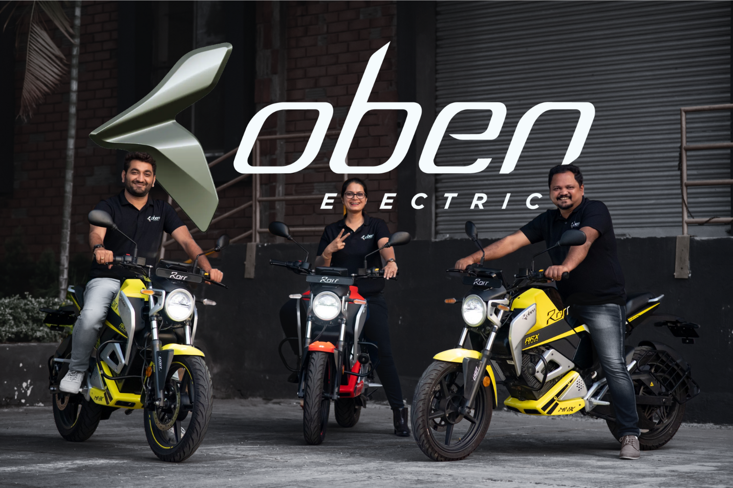The image features the branding of "Oben Electric" with its logo prominently displayed at the center. Three individuals, dressed in Oben Electric uniforms, are seated on brightly colored electric motorcycles—two yellow and one red—against an industrial backdrop. The image showcases the brand's sleek and innovative electric vehicles.
