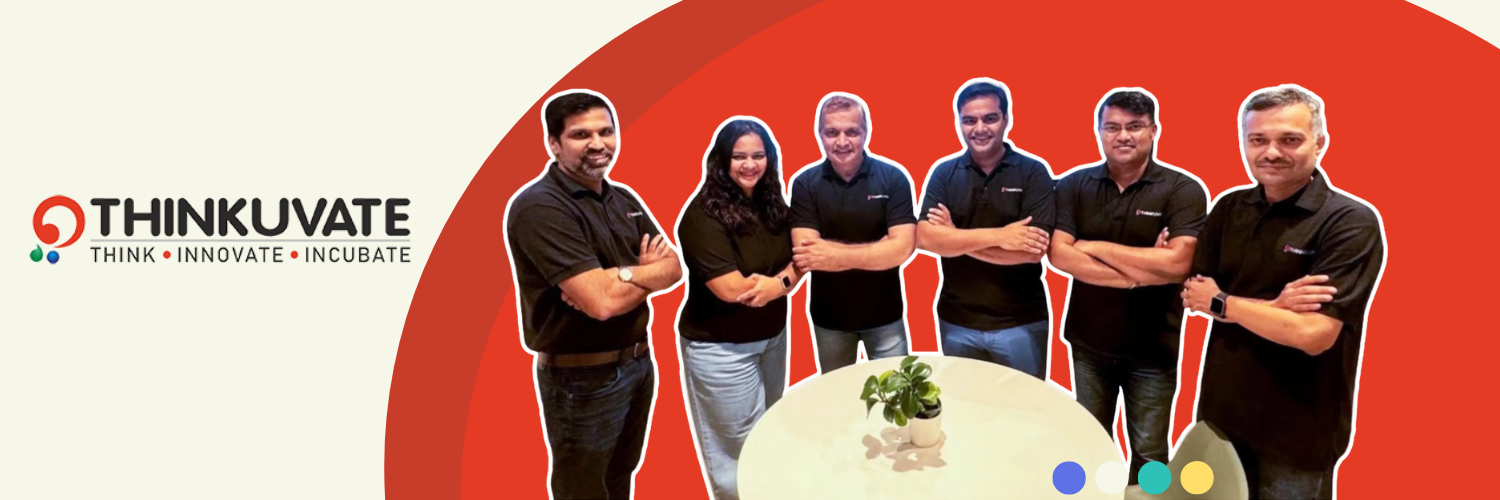 Banner image for Thinkuvate, featuring six team members standing around a small, round table with a plant in the center. The team, consisting of five men and one woman, are dressed in black polo shirts and smiling confidently. The background is a bold red with the Thinkuvate logo in the upper left corner, which includes the words 'THINK • INNOVATE • INCUBATE' alongside a colorful graphic.