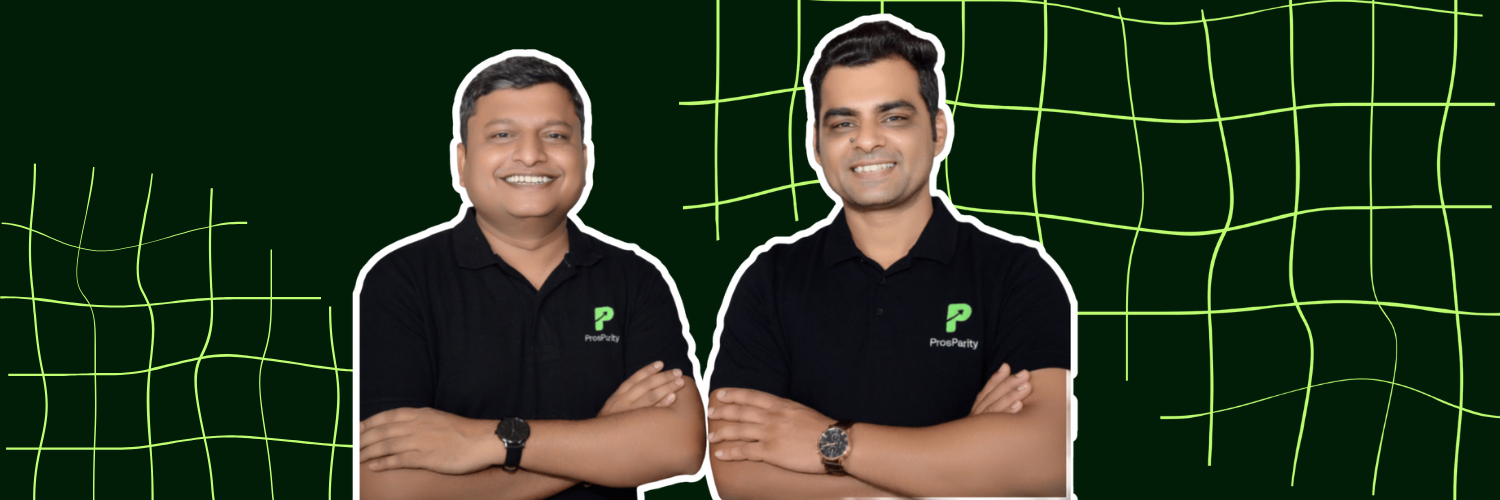 The image features Saurabh Khodke and Anirudh Dhakar, the co-founders of ProsParity. Both men are smiling and posing with their arms crossed, dressed in black polo shirts bearing the ProsParity logo, set against a green background with a subtle grid pattern. They appear professional and approachable, representing their company.