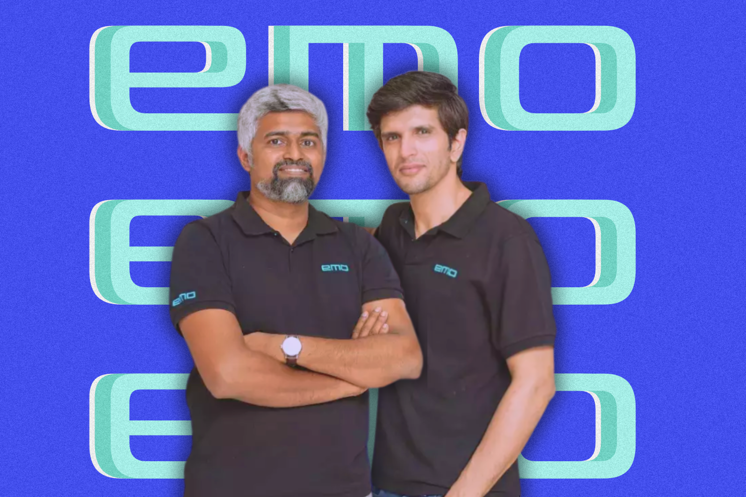 Two men wearing black polo shirts with the "emo" logo pose together against a vibrant blue background. The word "emo" is repeated in bold, stylized turquoise text in the background, creating a dynamic visual effect.