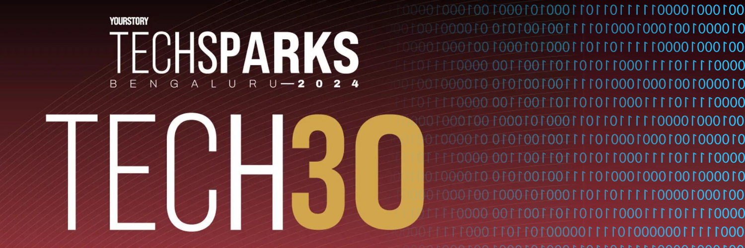 Promotional banner for YourStory's TechSparks Bengaluru 2024 event, featuring Tech30. The banner has a dark red gradient background with binary code patterns on the right. The text reads "YourStory TechSparks Bengaluru 2024" at the top, and "Tech30" in large white and gold letters in the center. The design is modern and tech-oriented, highlighting the significance of the Tech30 showcase at the event.