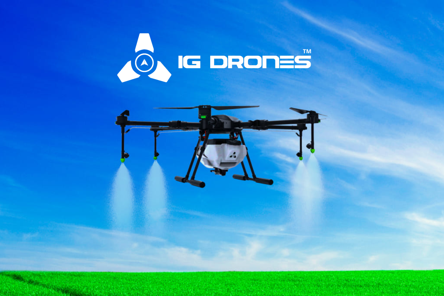 The image features a drone in flight over a vibrant green field with a clear blue sky in the background. The drone appears to be spraying a substance from two nozzles beneath it. Above the drone, there is a logo that includes a three-part triangular symbol and the text "IG DRONES™," both in white. The scene suggests agricultural or industrial use of the drone for tasks like crop spraying.
