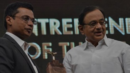 Sachin Bansal receiving an award from P. Chidambaram at an event, with the text "Entrepreneur of the Year" visible in the background.