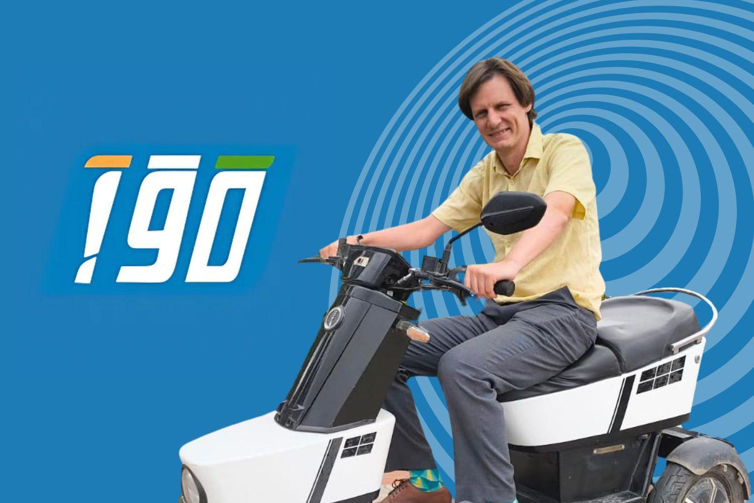 "A man in a yellow shirt smiles while sitting on a modern electric scooter, with the 'iGO' logo on a vibrant blue background."