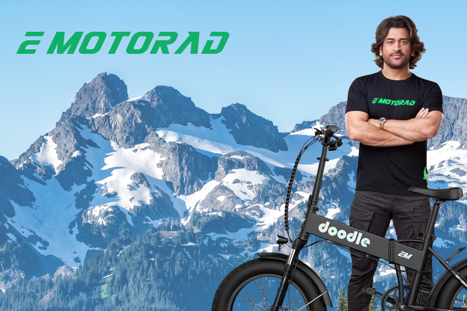 The image features a person standing with their arms crossed, wearing a black t-shirt with the "EMotorad" logo printed on it. Next to them is an electric bike branded as "Doodle EM." The background showcases a scenic mountain range with snow-capped peaks under a clear blue sky, creating a striking contrast with the foreground. The overall vibe of the image highlights adventure, eco-friendly travel, and confidence.