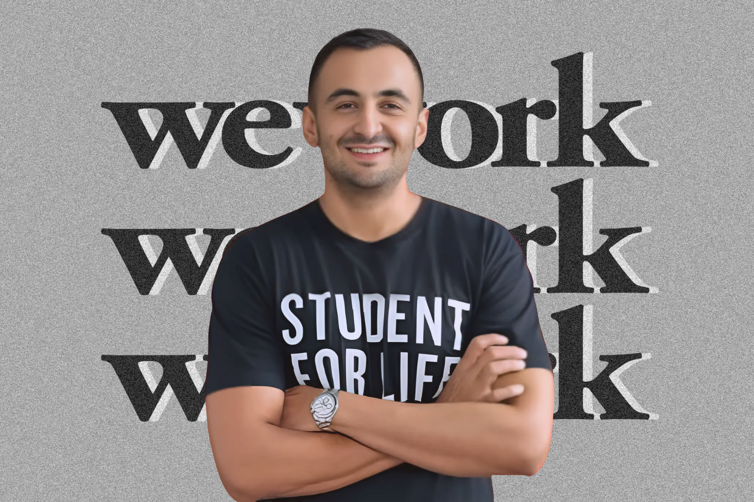 A man wearing a black T-shirt with the text 'Student for Life' stands confidently with arms crossed. The backdrop features a minimalist, textured gray design with the word 'WeWork' repeated three times in bold black font