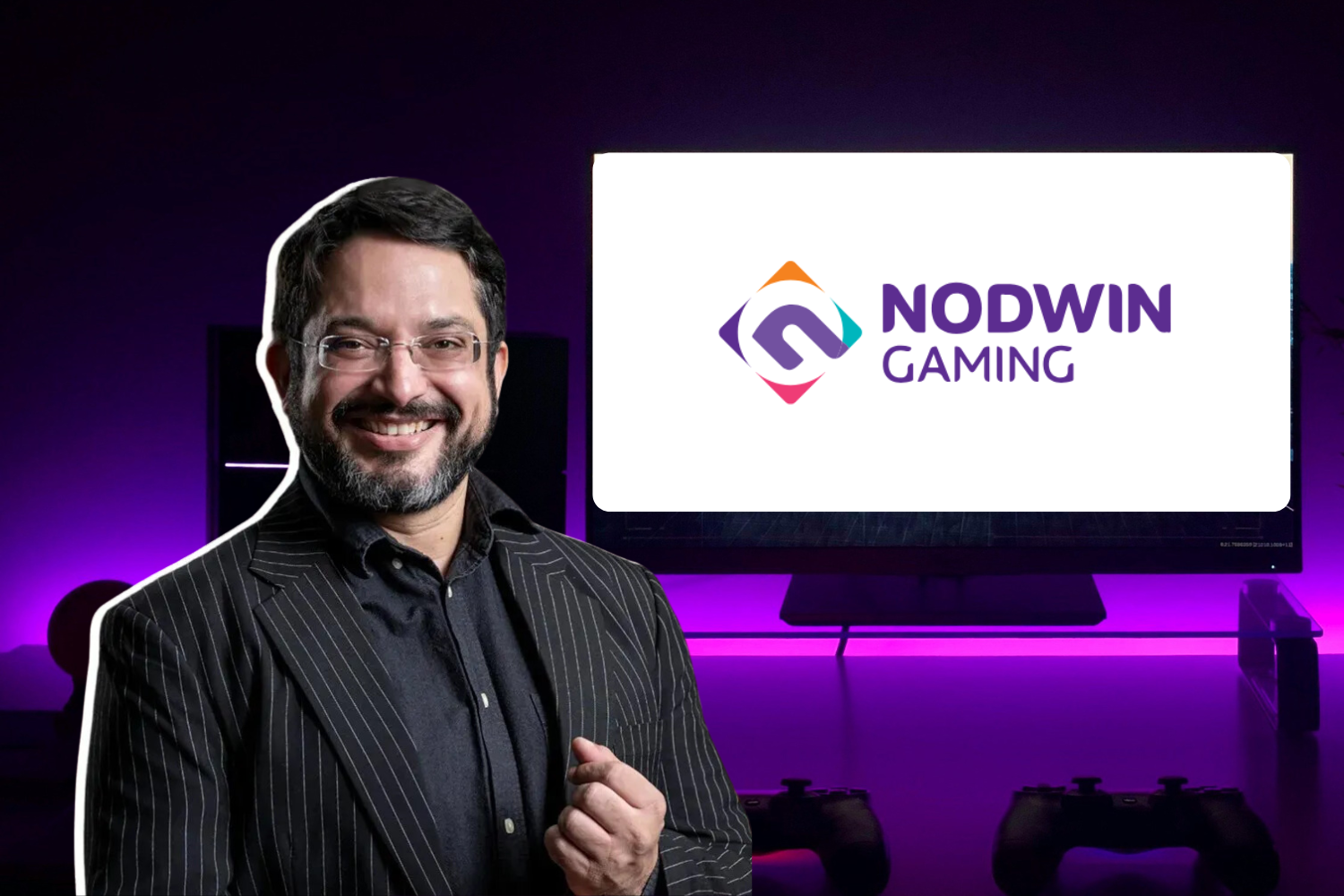 The image shows a man in a pinstripe blazer and glasses smiling confidently, with a purple-lit gaming setup in the background. On the right, a screen prominently displays the "NODWIN GAMING" logo in vibrant colors. The composition suggests a professional association with the gaming industry, highlighting innovation and leadership.