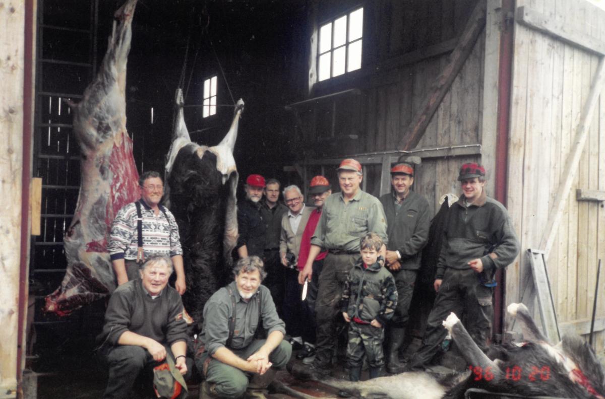 Group photo with Kjell, Lennart, Emil and other hunters skinning a moose.