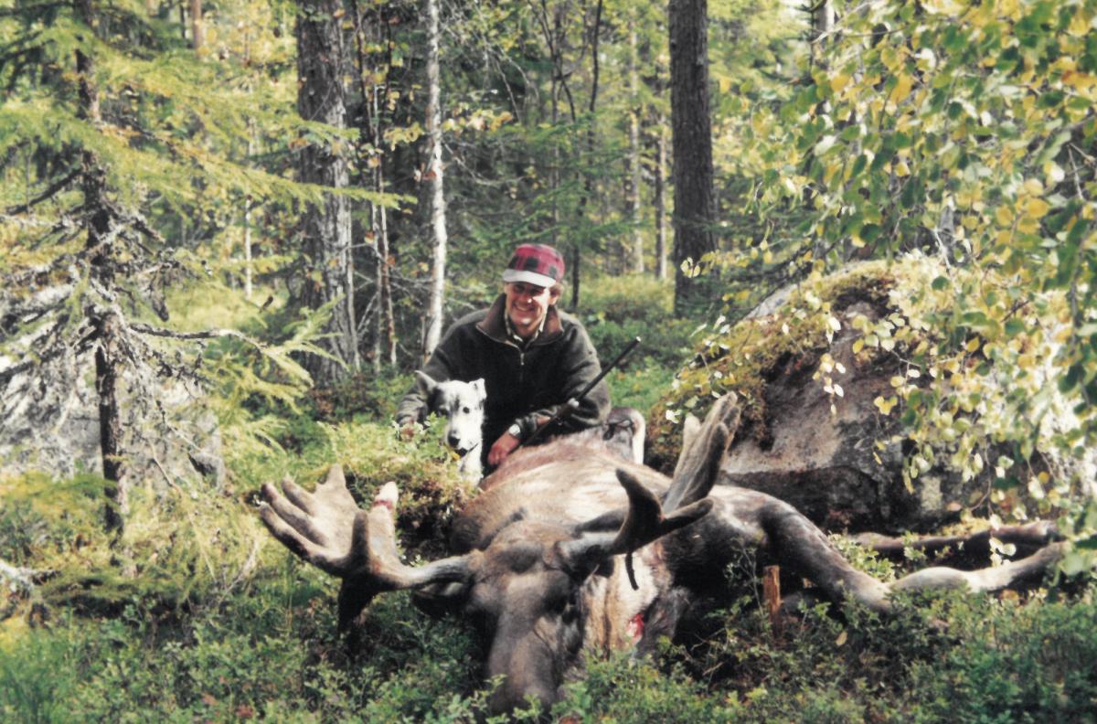 Kjell with his dog and a hunted moose.