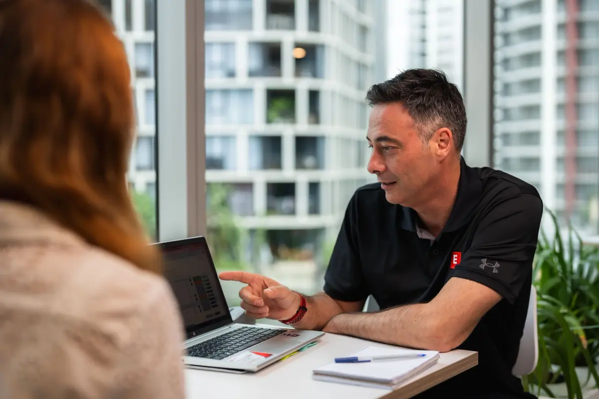 Envest staff member pointing to computer