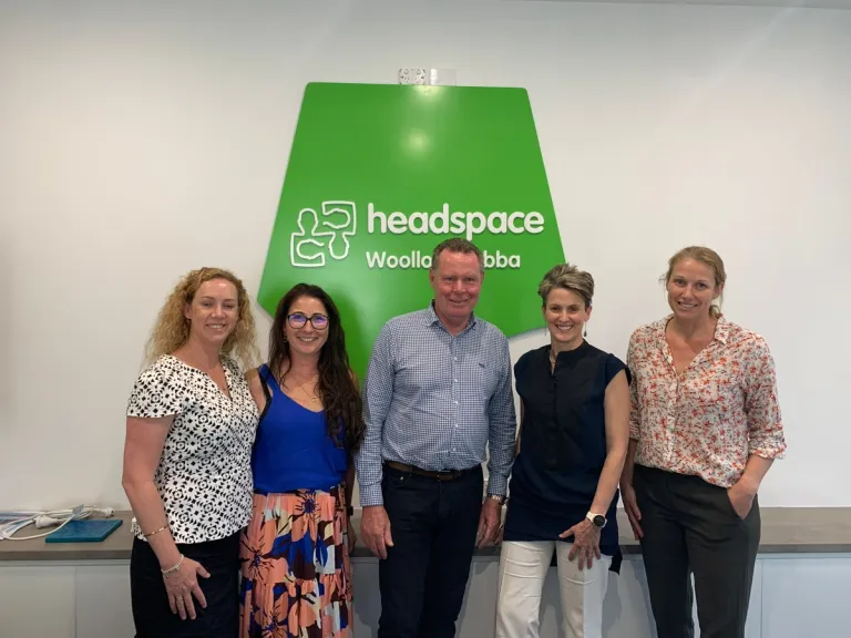 Envest chairman Paul Lynam (middle) with representatives from headspace and Envest to sign the new partnership deal