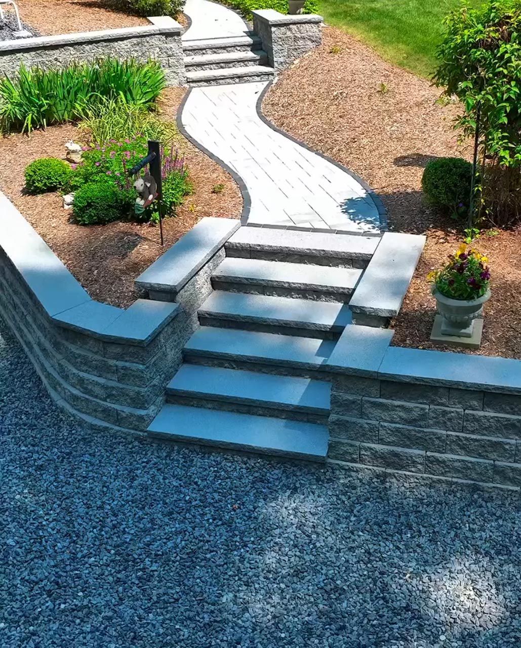 Precision hardscape installation with stone steps, paver walkway, and retaining wall by Contrast Landscape in southeastern Massachusetts