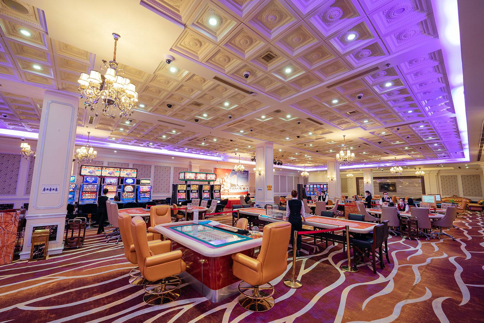 Club gaming floor with tables under warm amber light