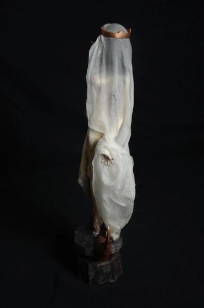 Virgin Mary's profile with crown and robe.