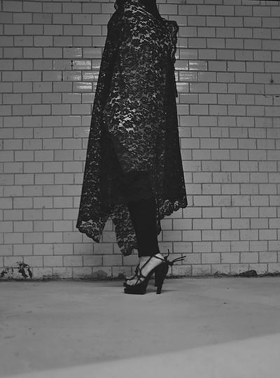 Brunete hiding behind a veil wearing stilettos