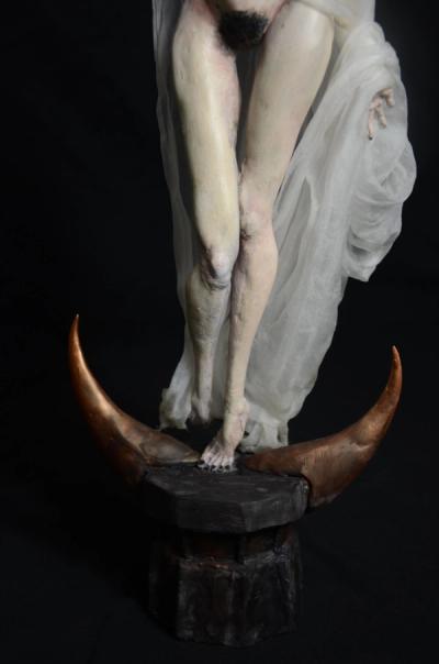 Naked ballerina's legs and feet on a crescent moon