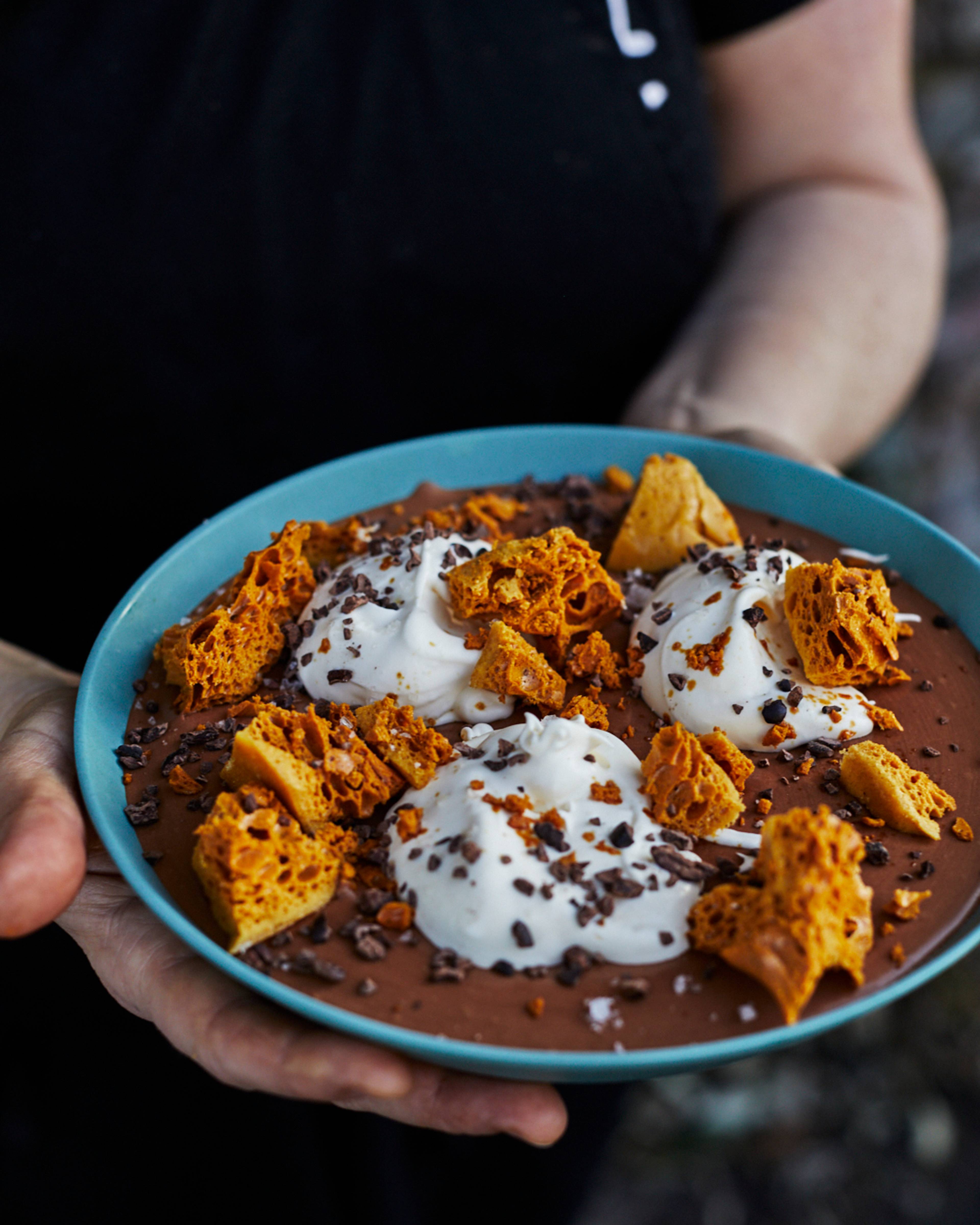 chocolate mousse in a bowl with creme anglaise and honeycome