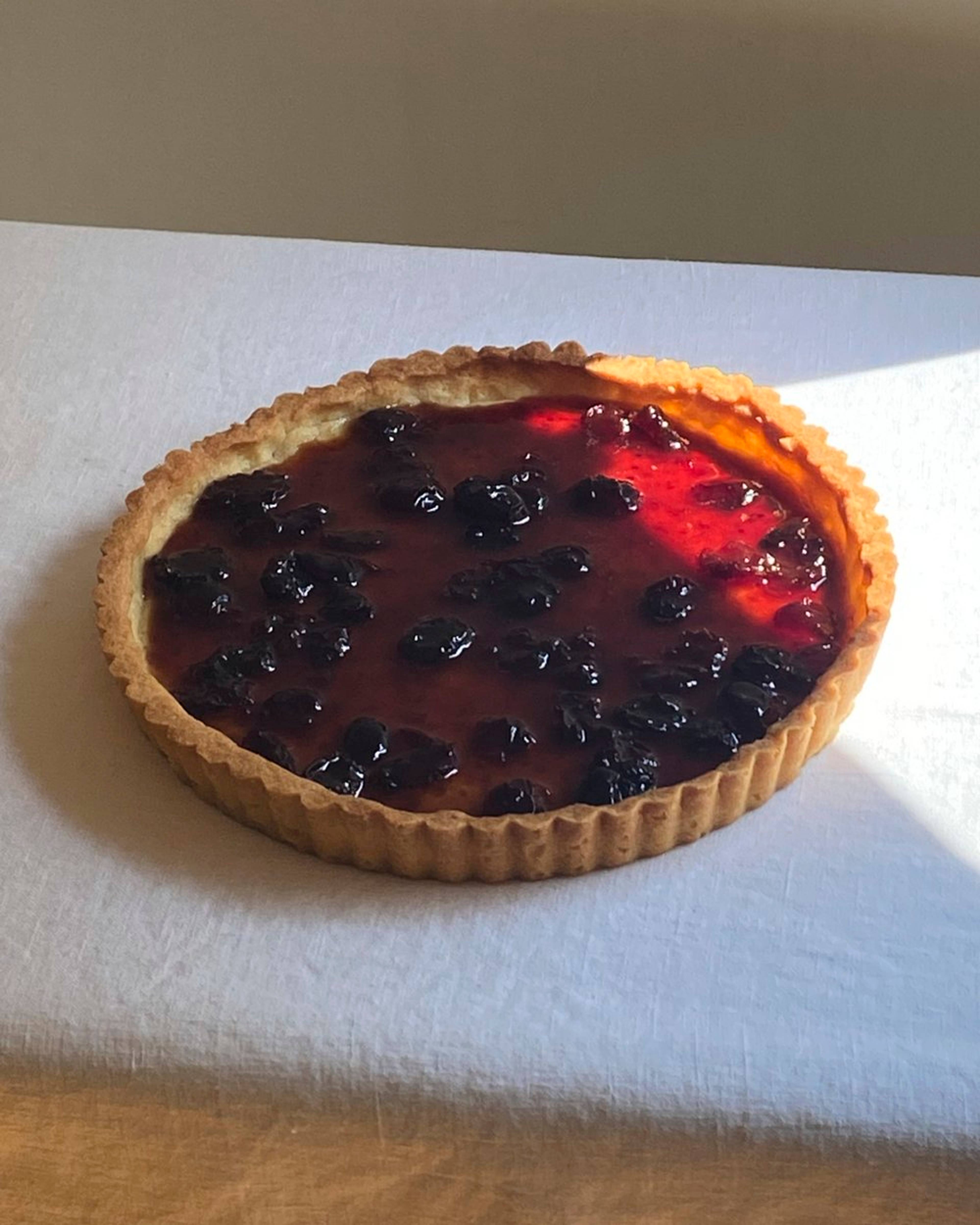 Cherry jam spread on tart base