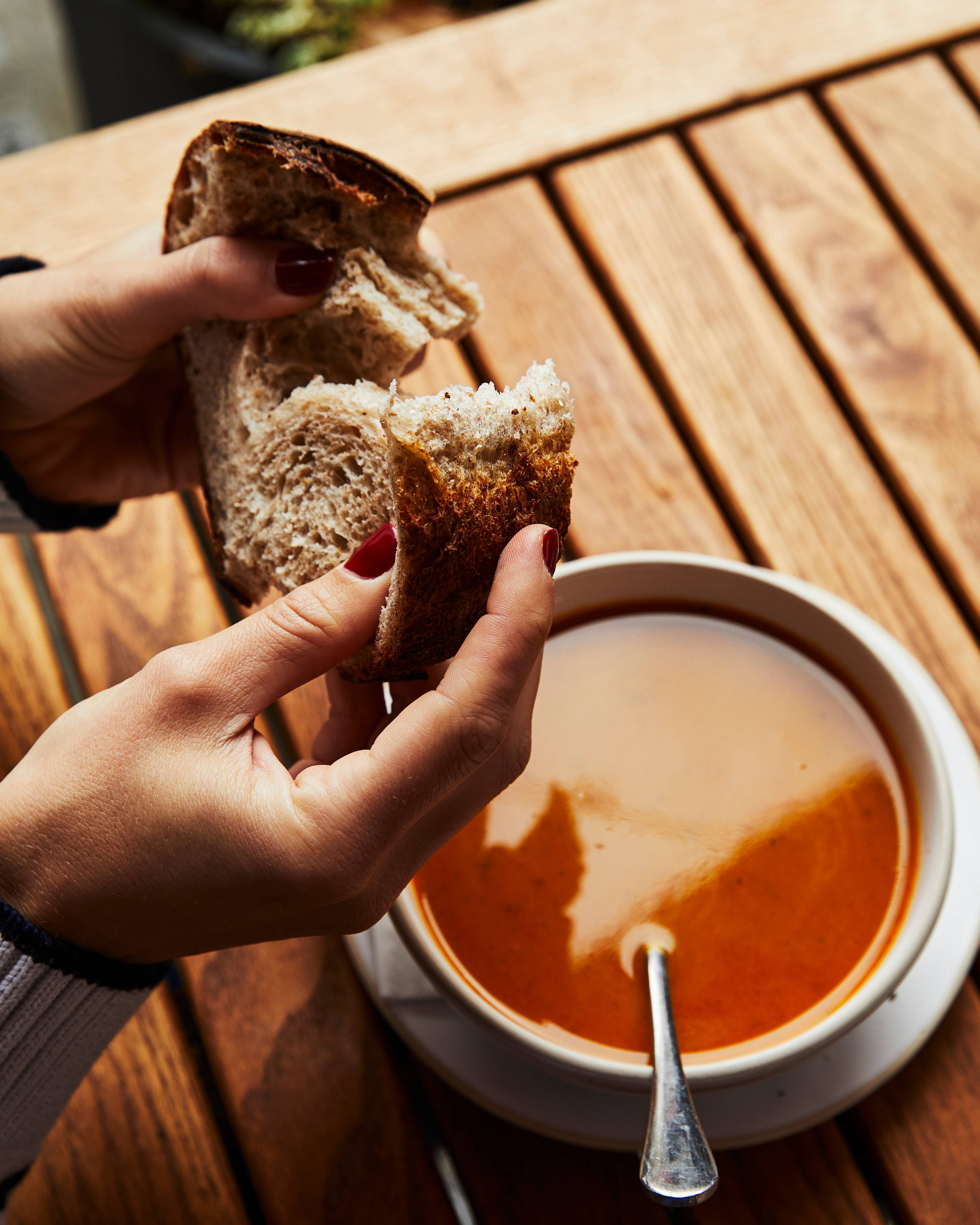 Tearing bread over Delica soup