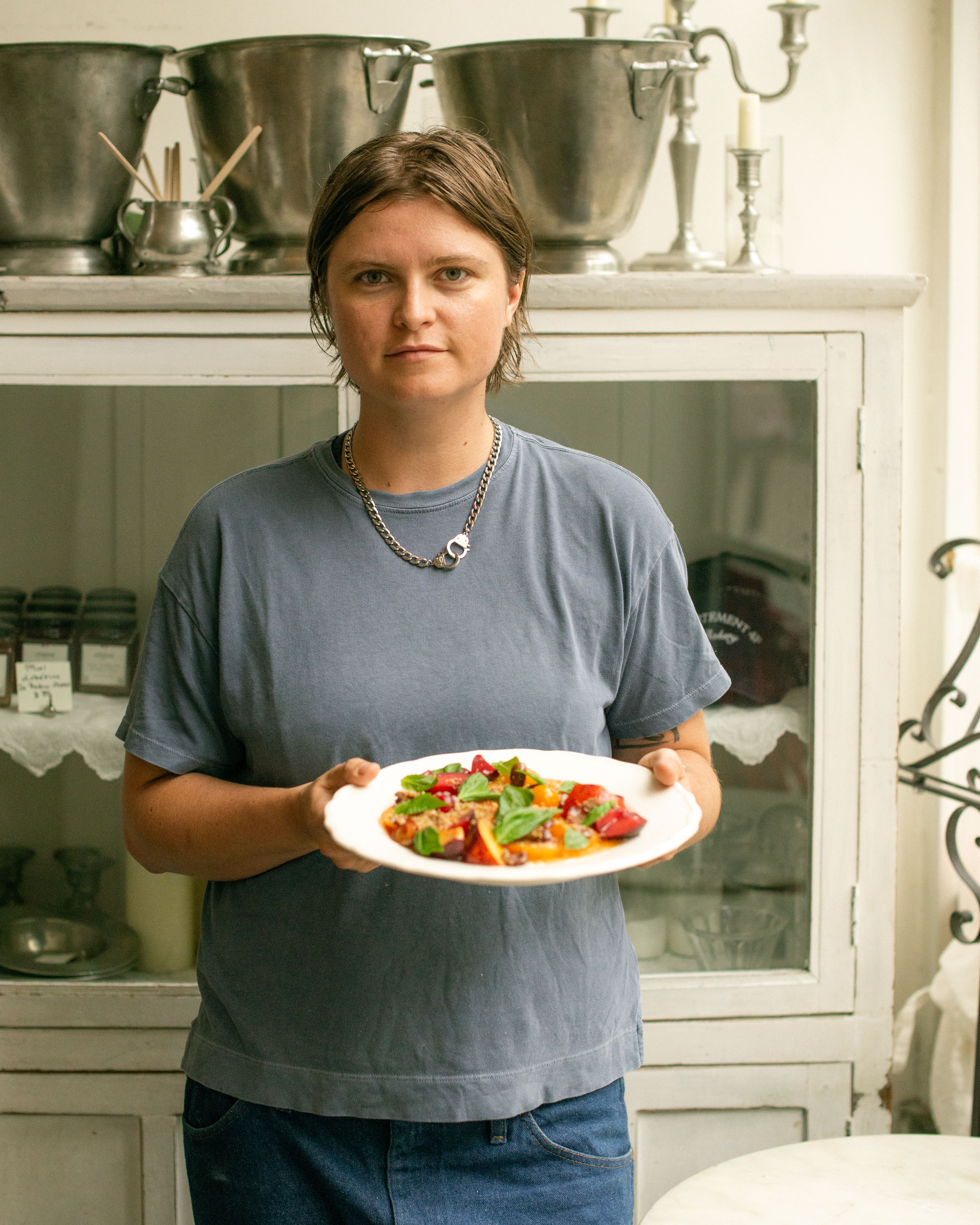 Person holding a plate with panzanella in a bakery