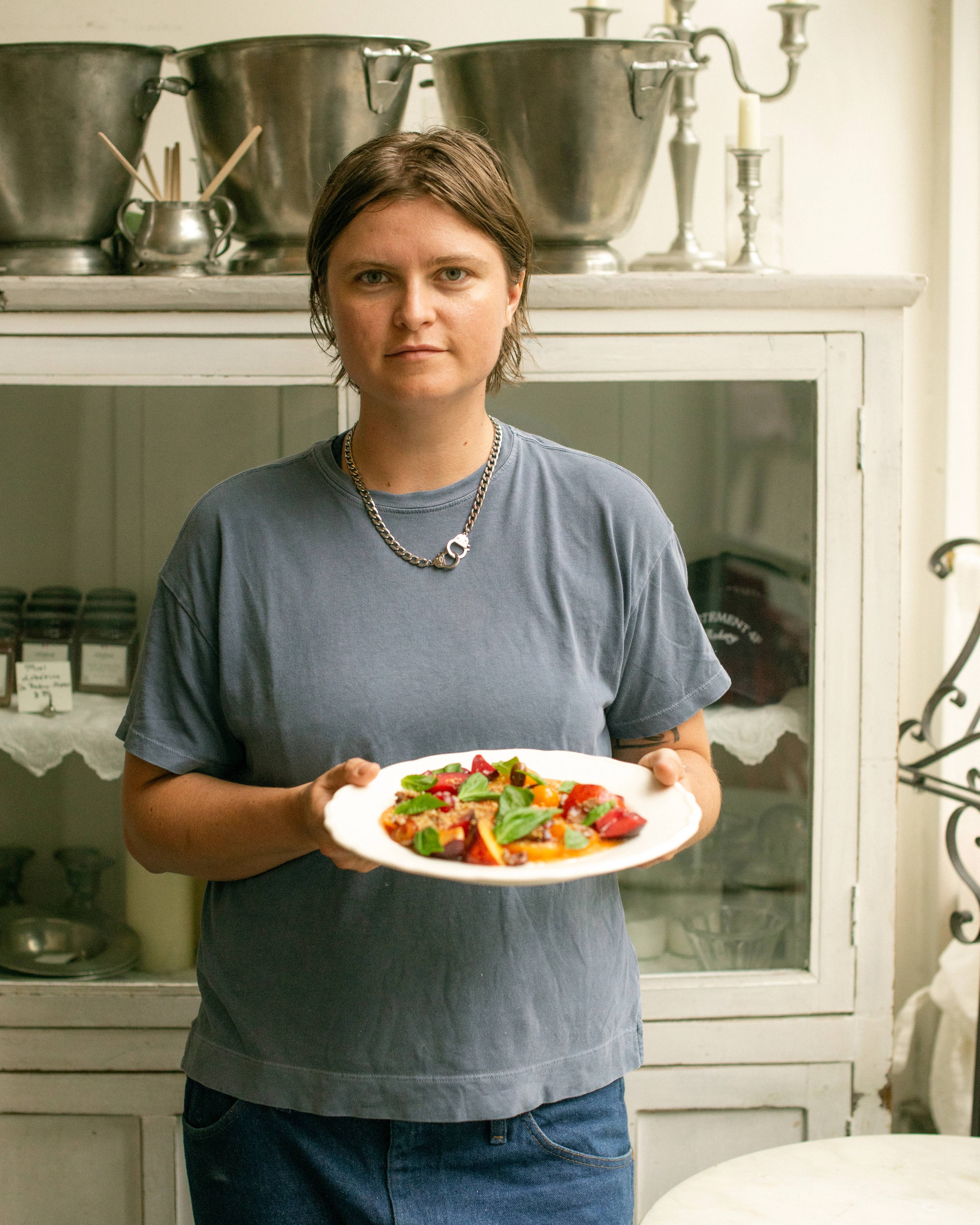 Person holding a plate with panzanella in a bakery