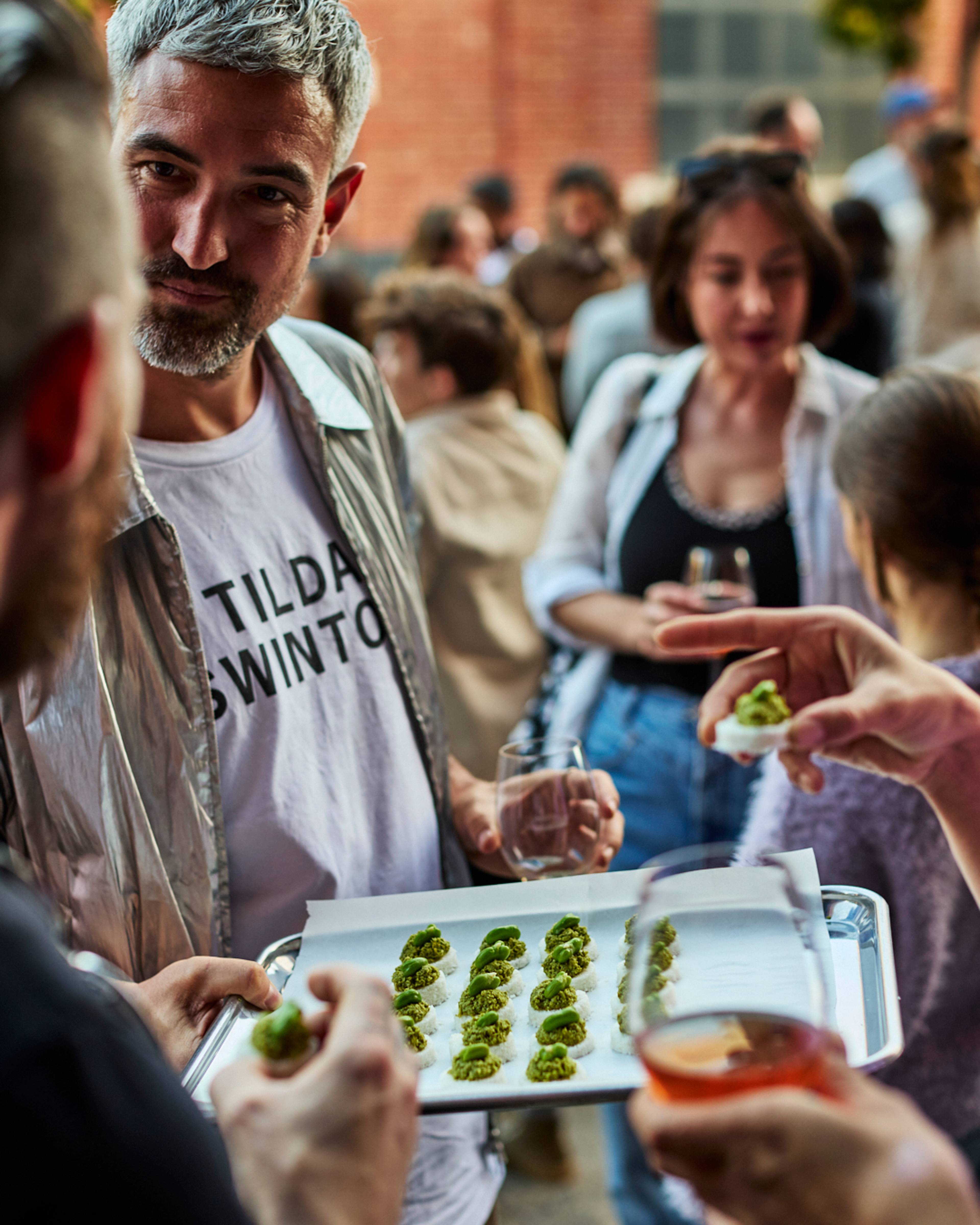 People at the Melbourne launch party with canapes and wine