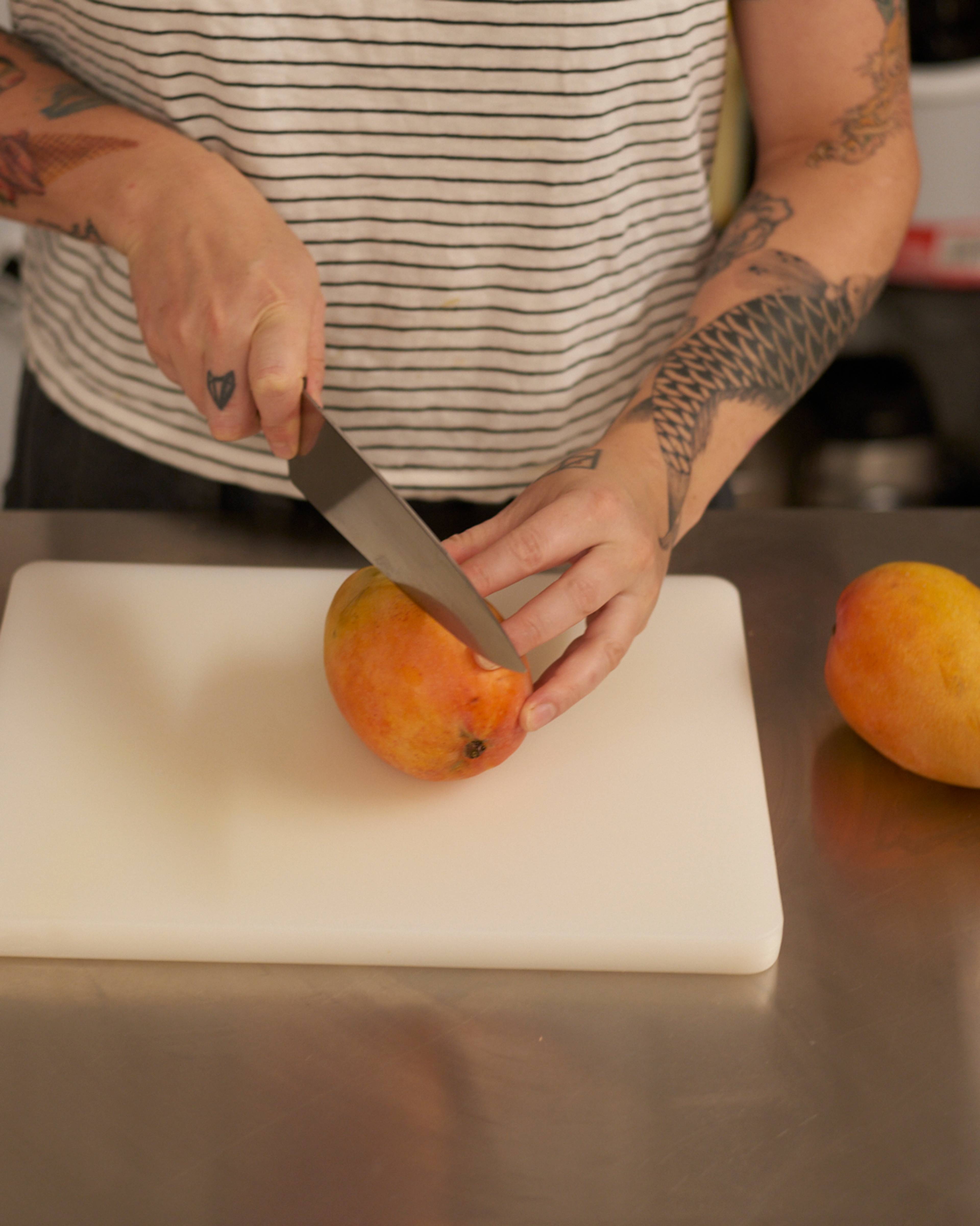 mango being sliced in half