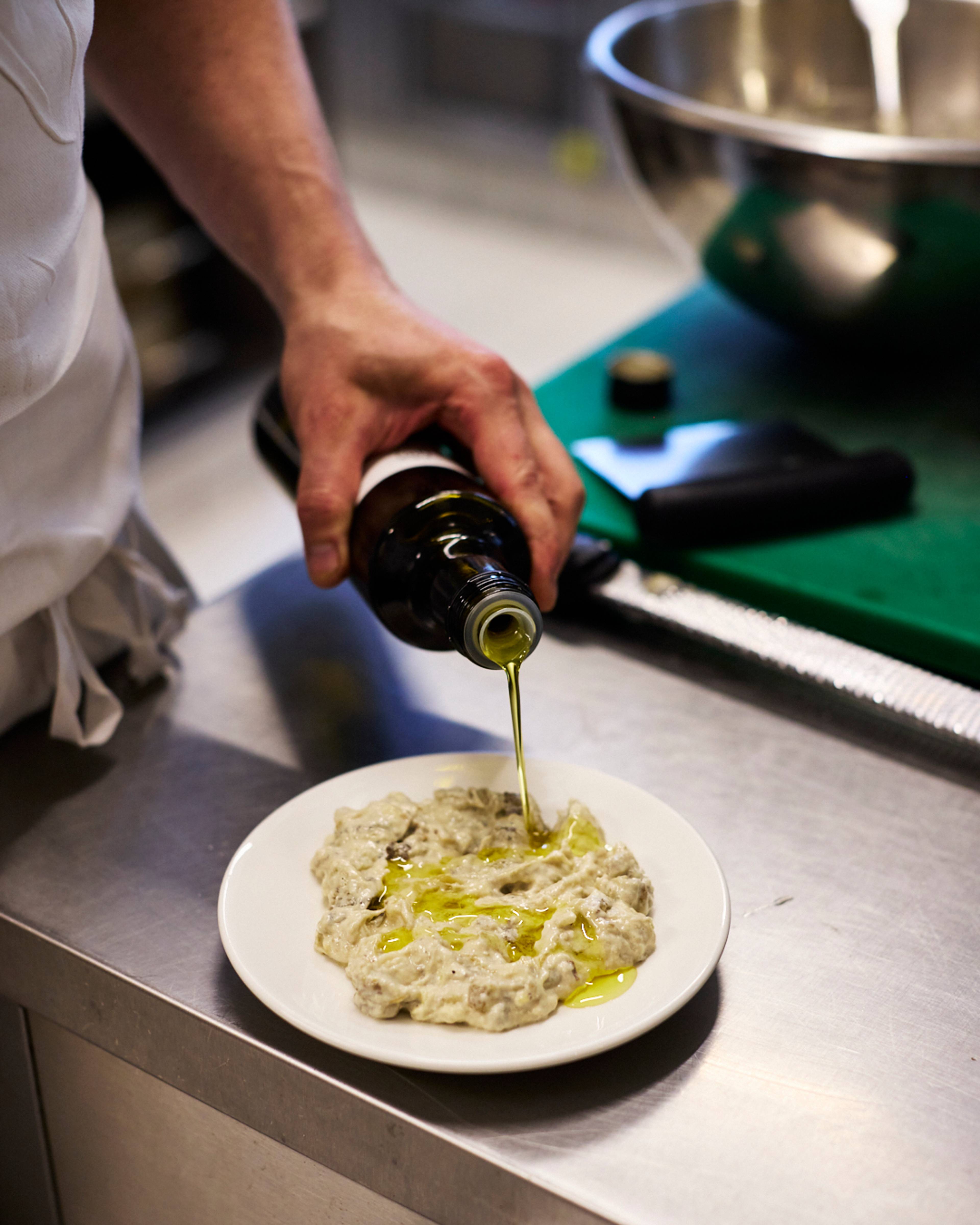 aubergine mouttabal being dressed with oil