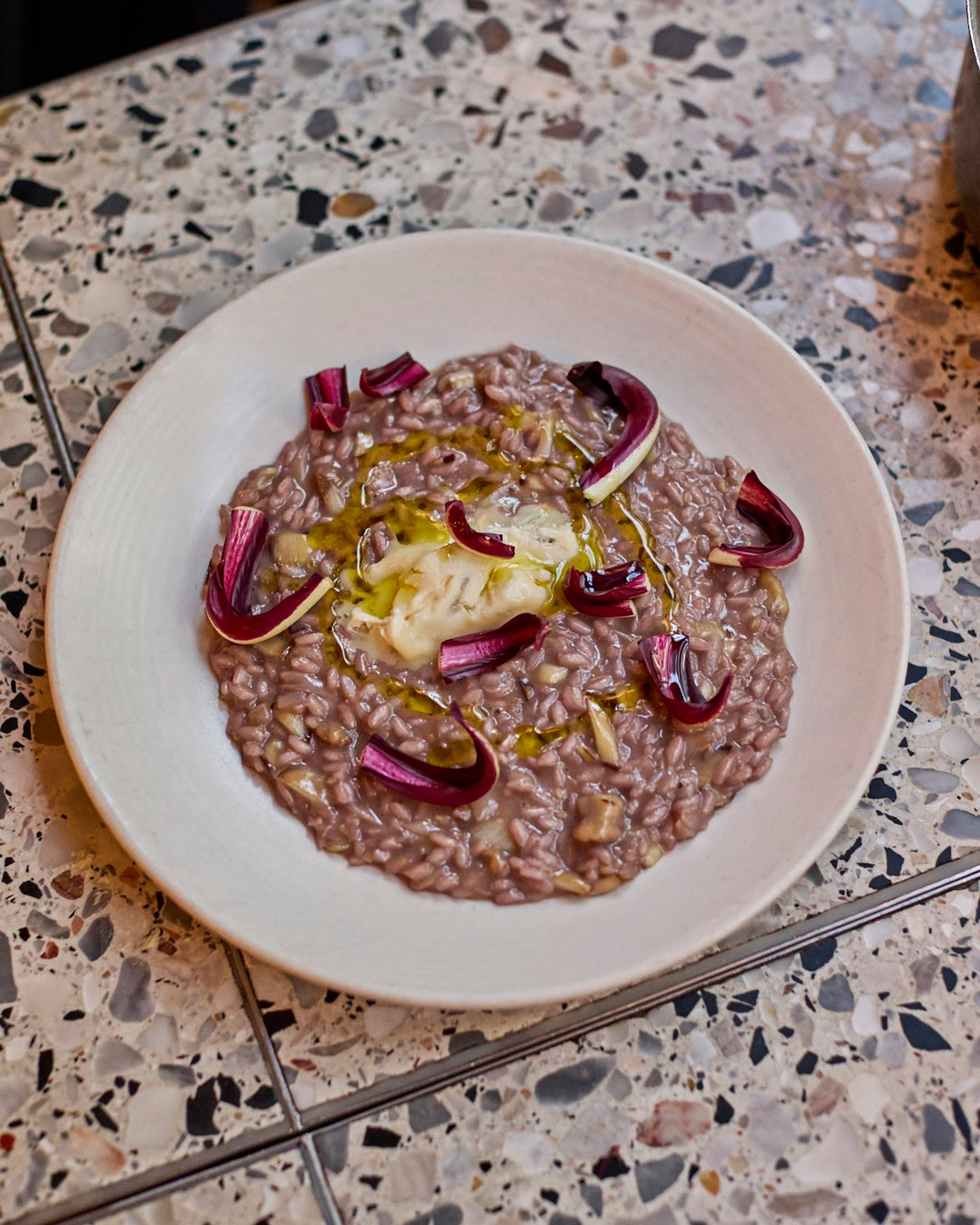 tardivo risotto served in a cream risotto dish