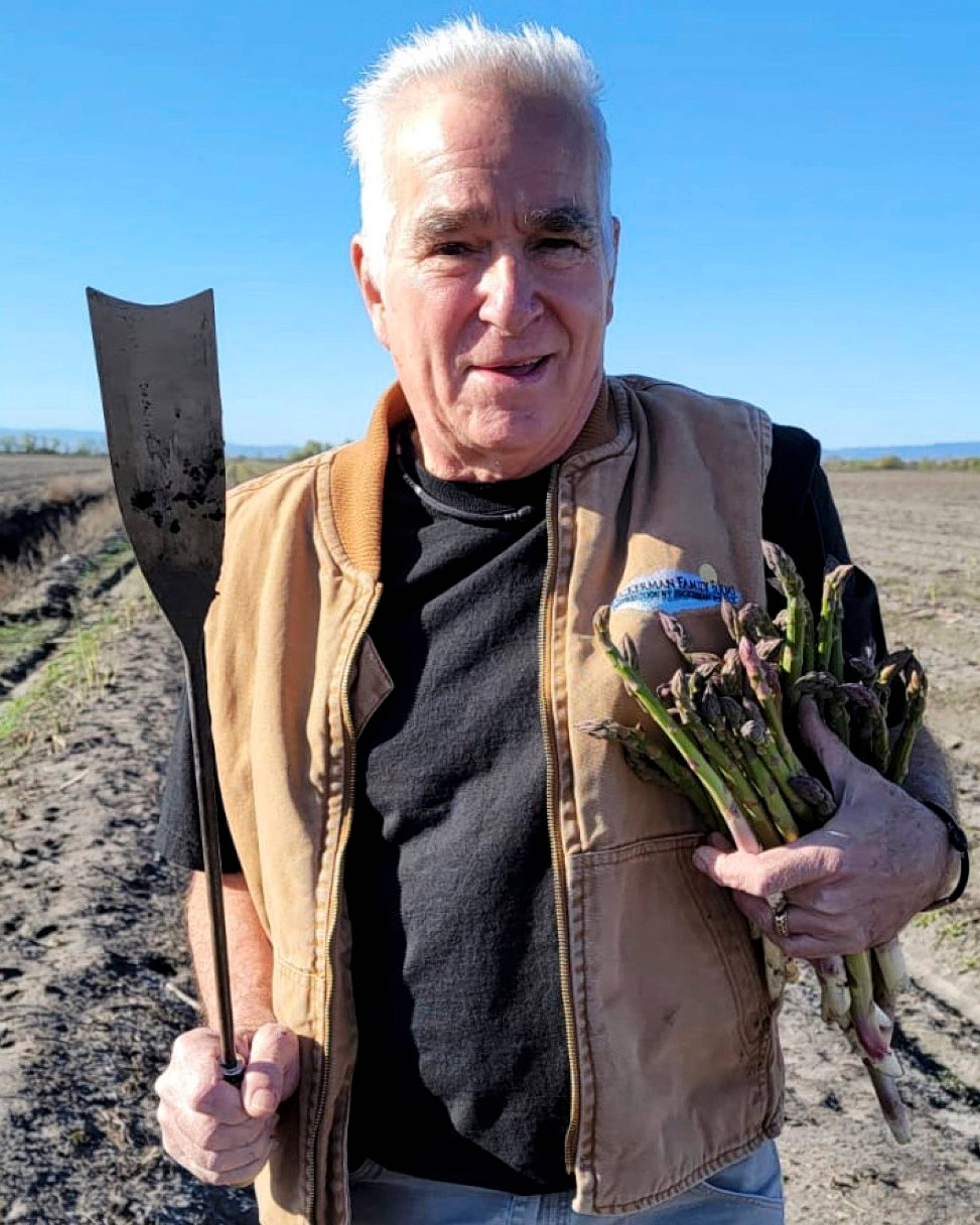 roscoe asparagus grower holding asparagus