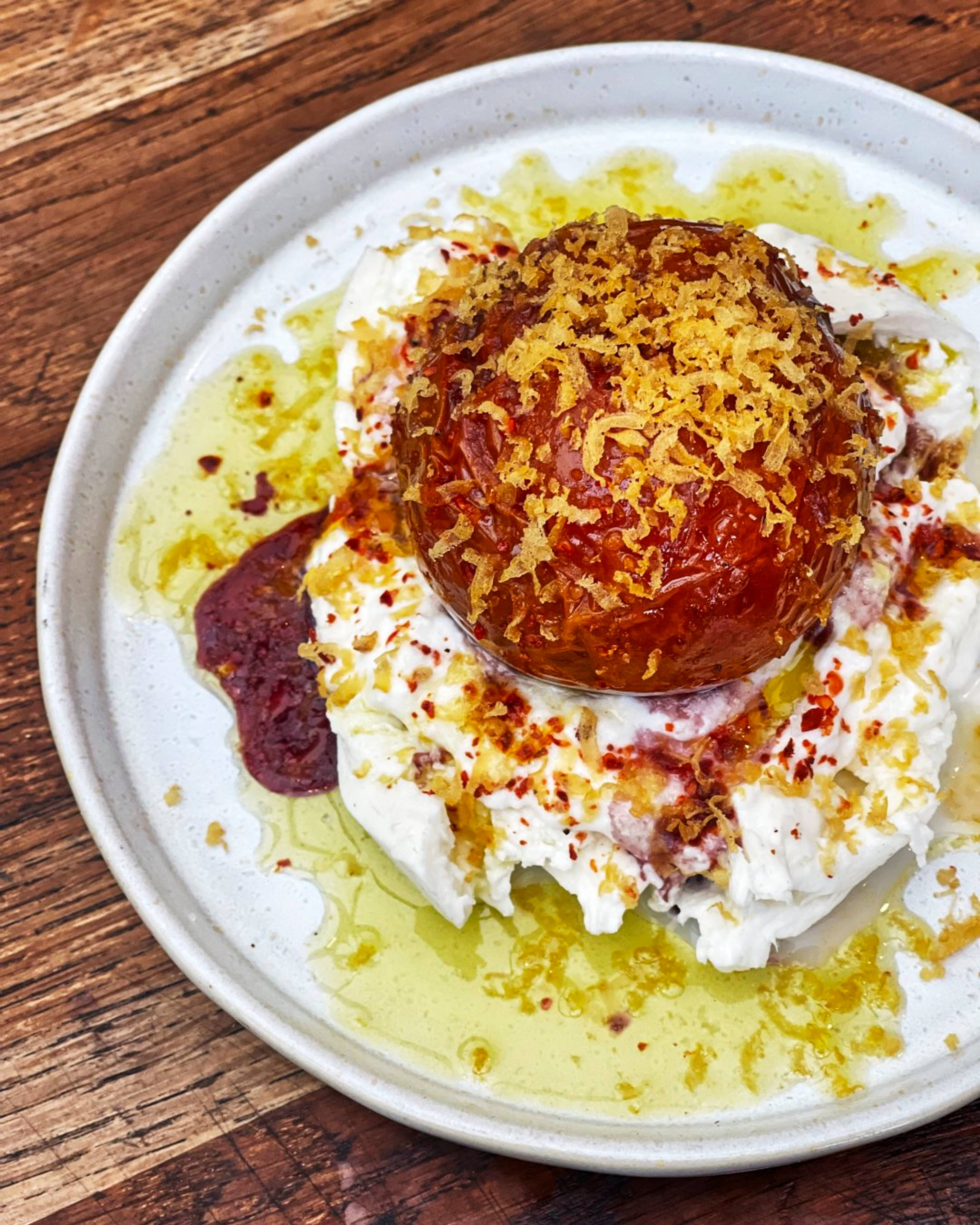 Plated burrata confit iberiko tomato and bottarga dish on a white plate