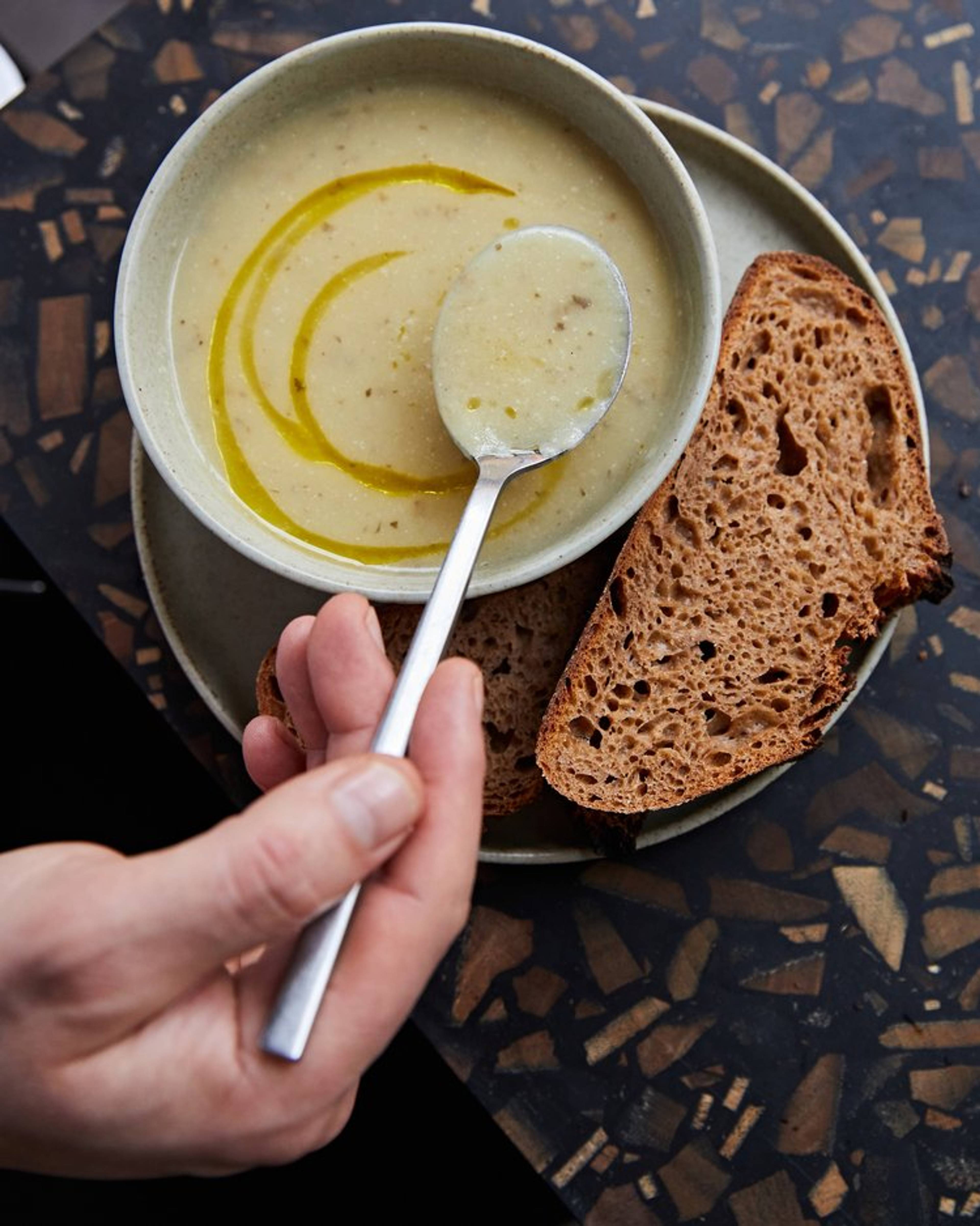 jerusalem and artichoke soup in a bowl and bread on the side