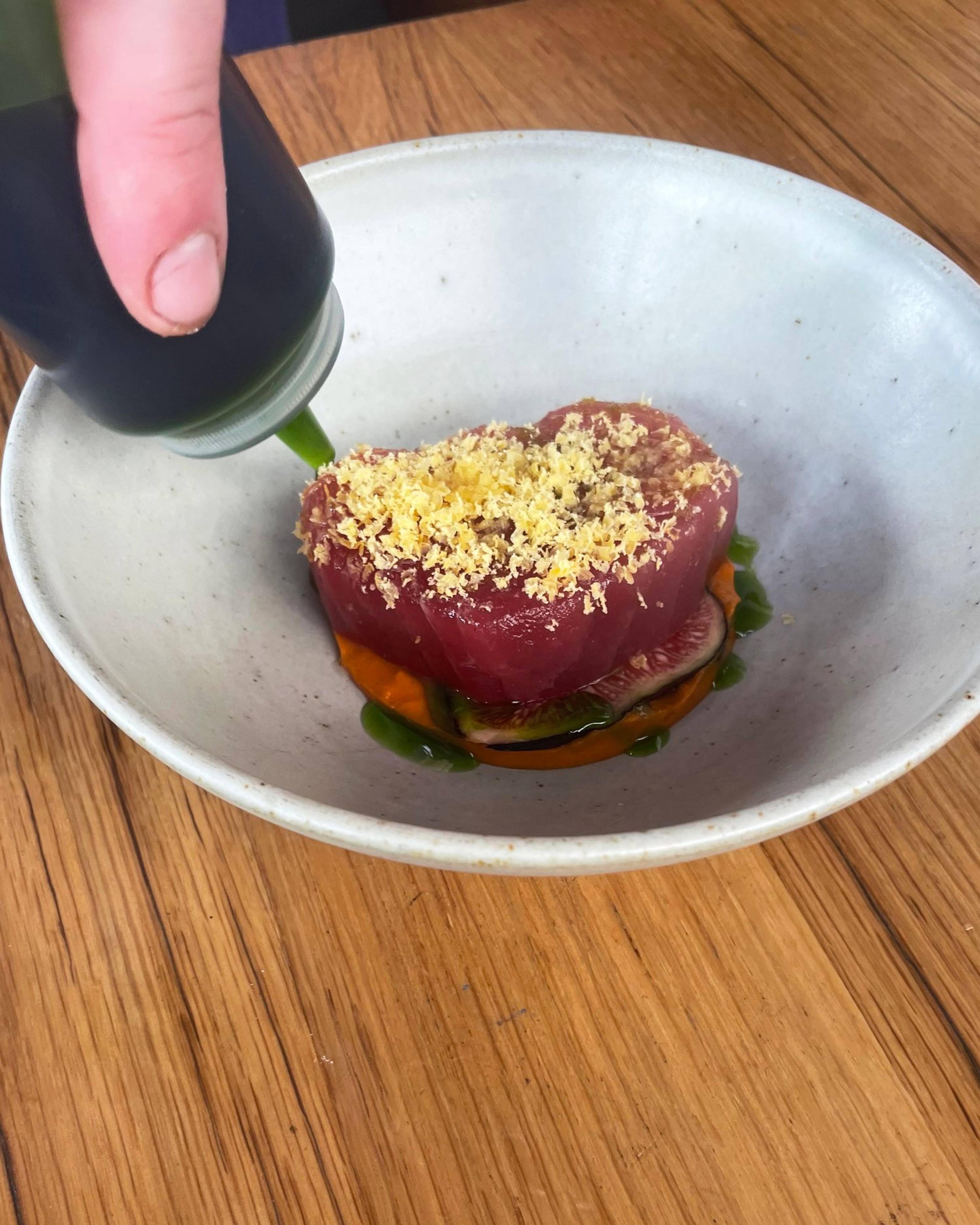 Raw tuna dish being plated