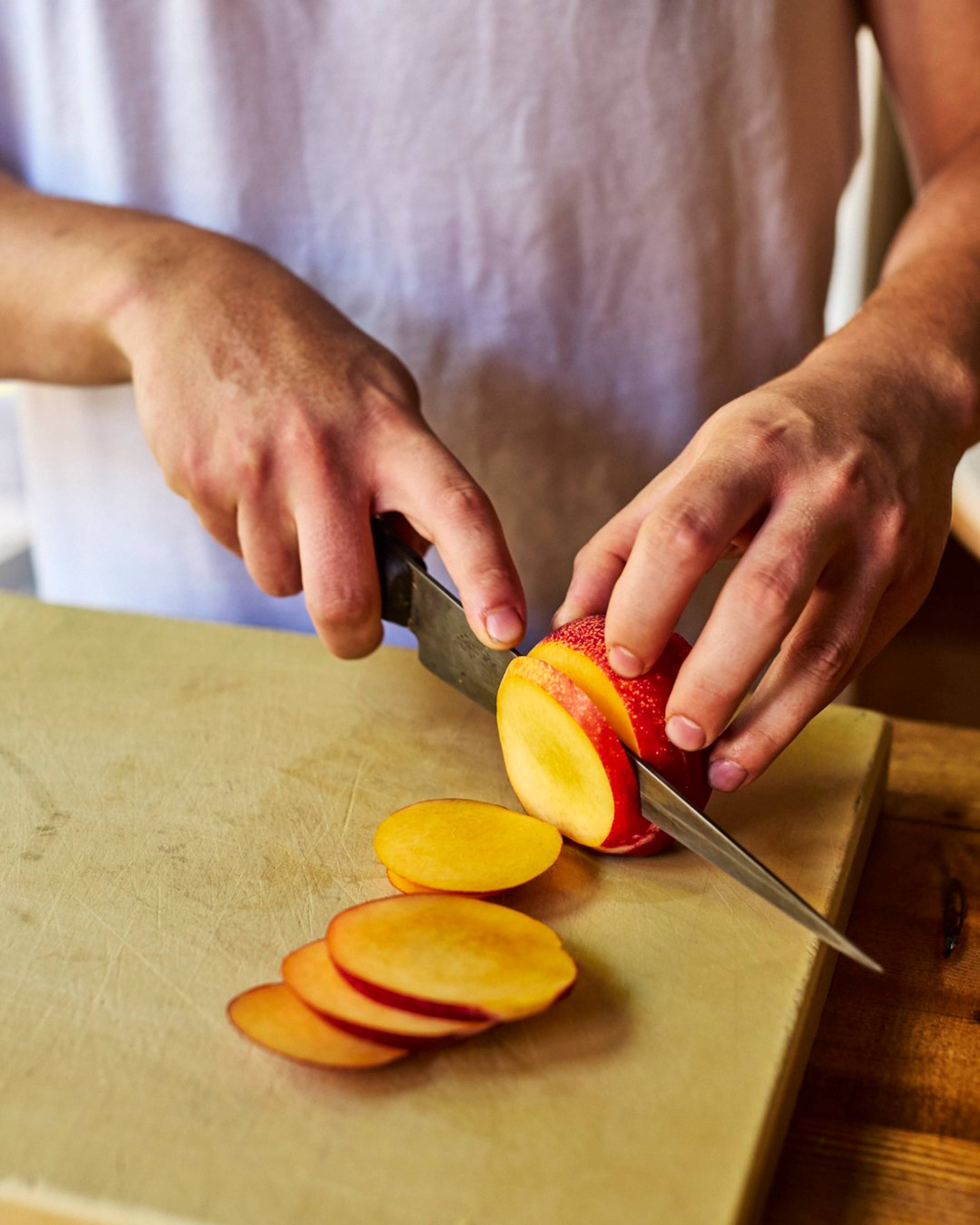 Yellow nectarine being sliced