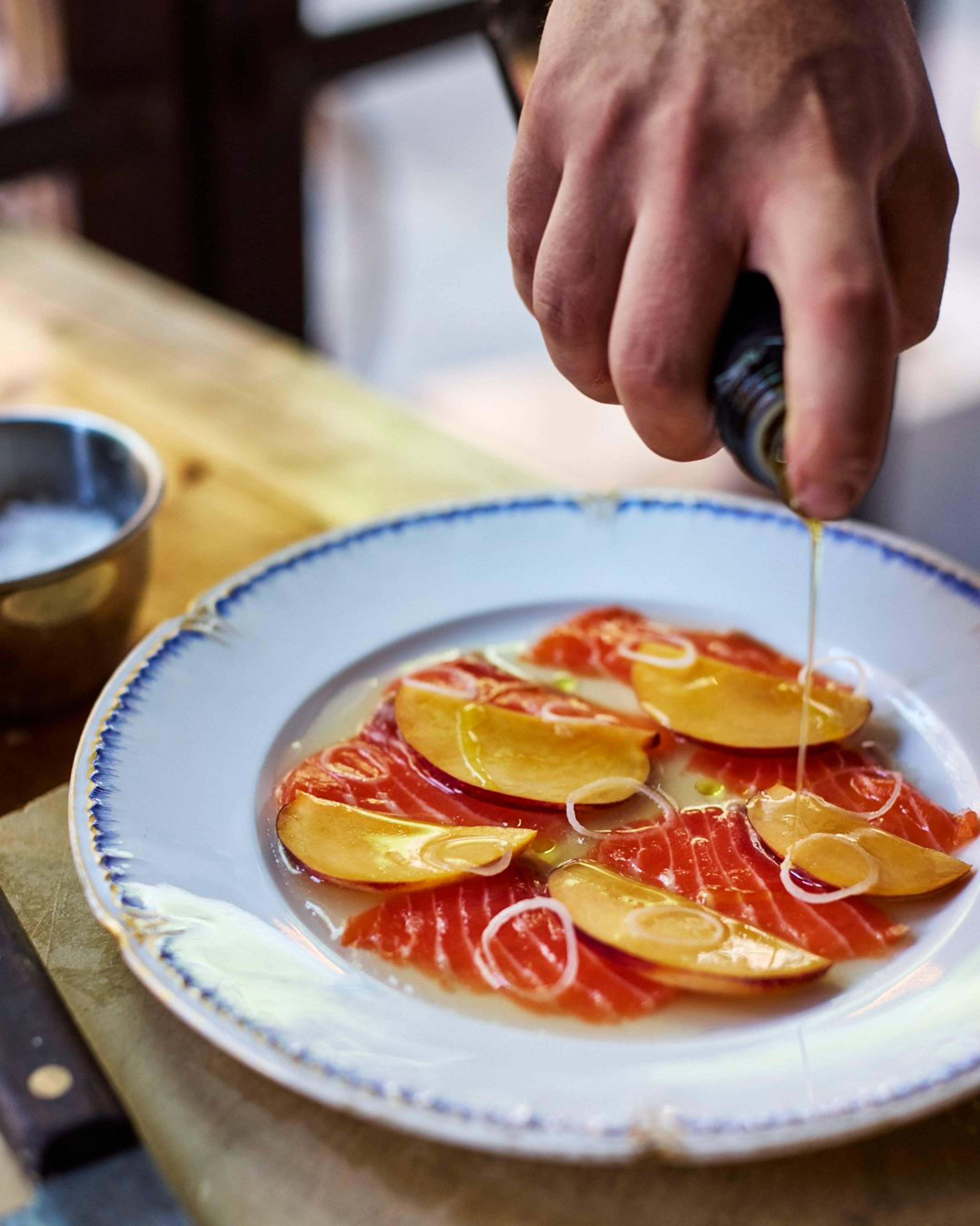 Olive oil drizzling over plated dish