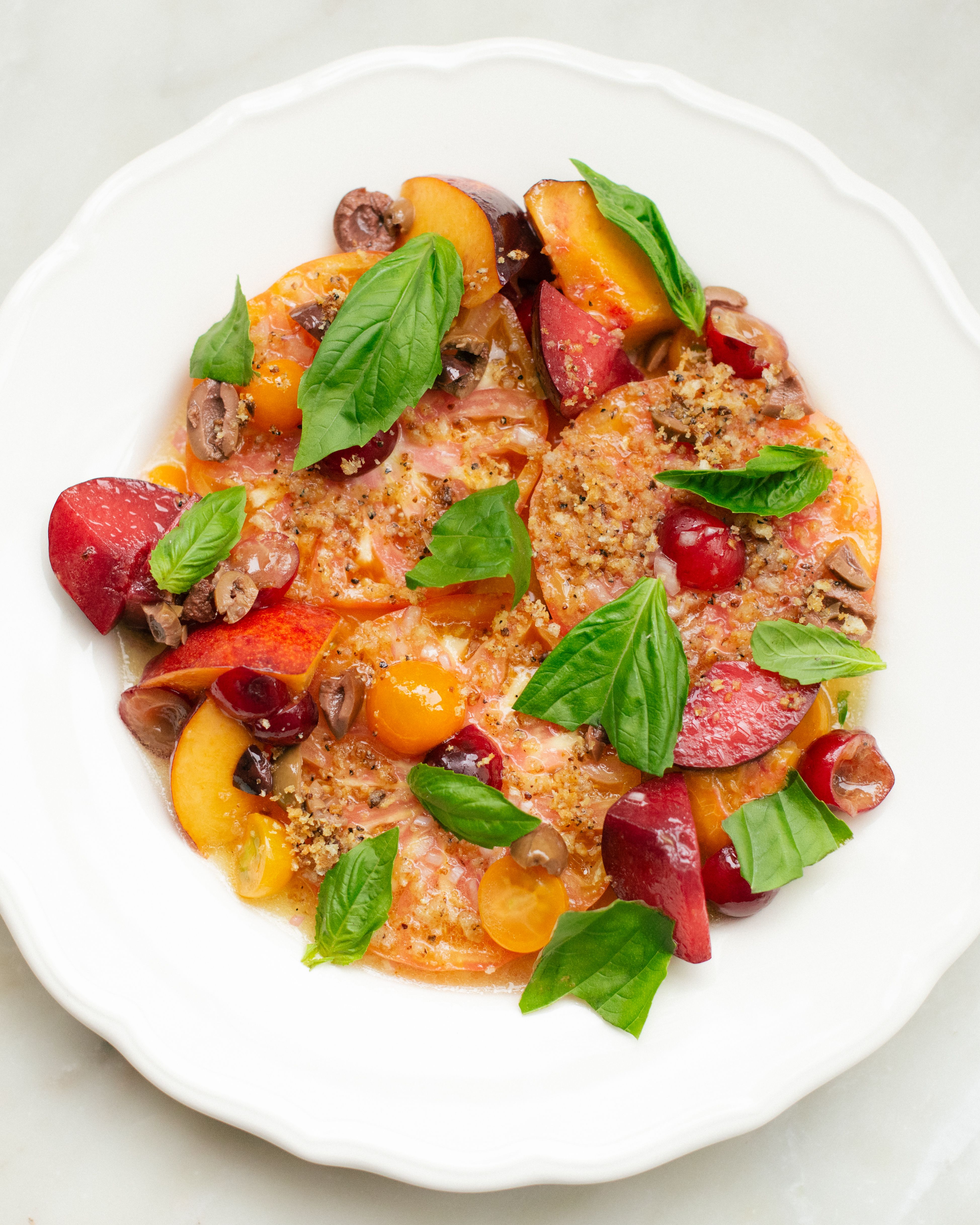 Tomatoes, peaches, and basil on plate