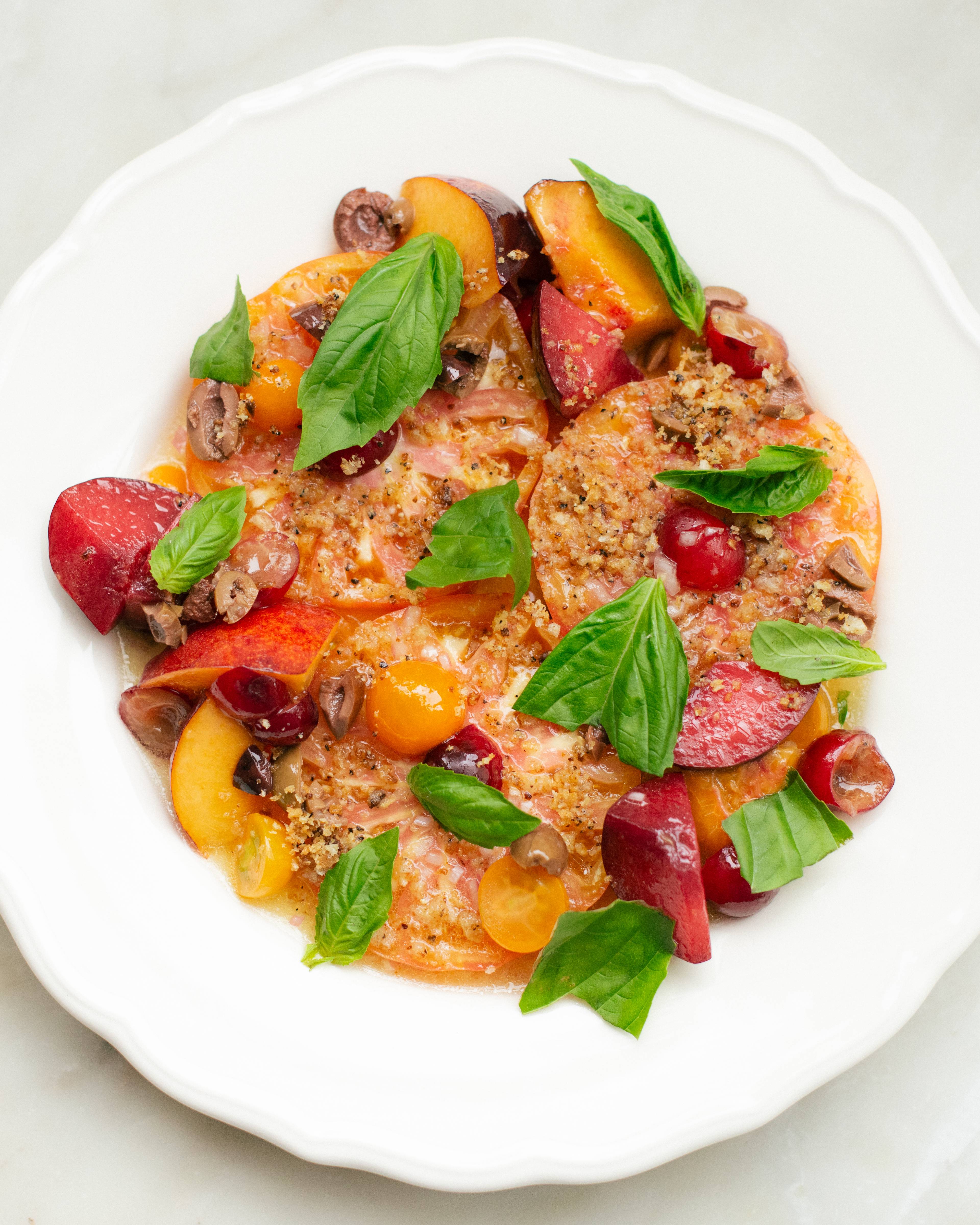 Tomatoes, peaches, and basil on plate