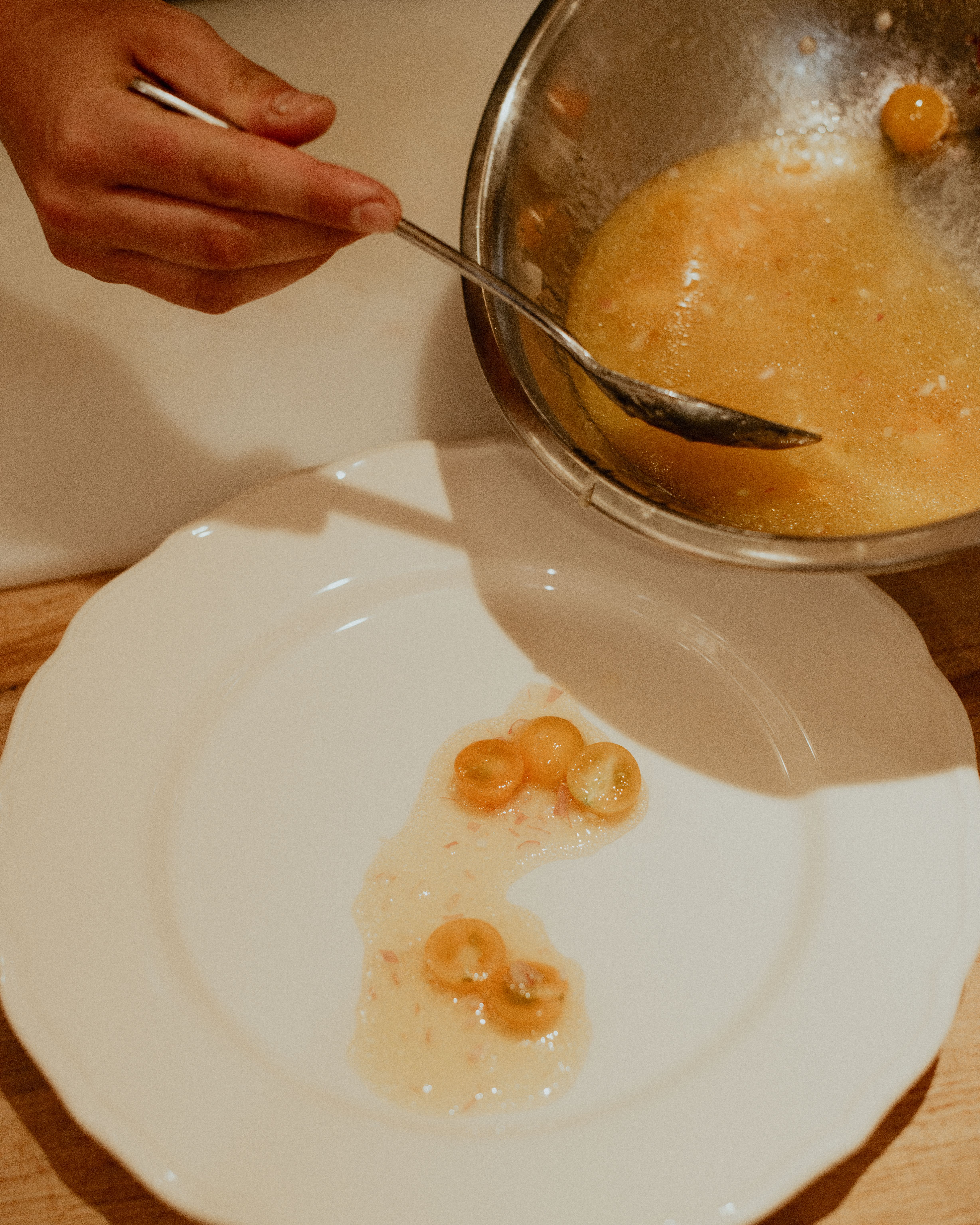 Sungold Tomatoes on white plate with silver bowl