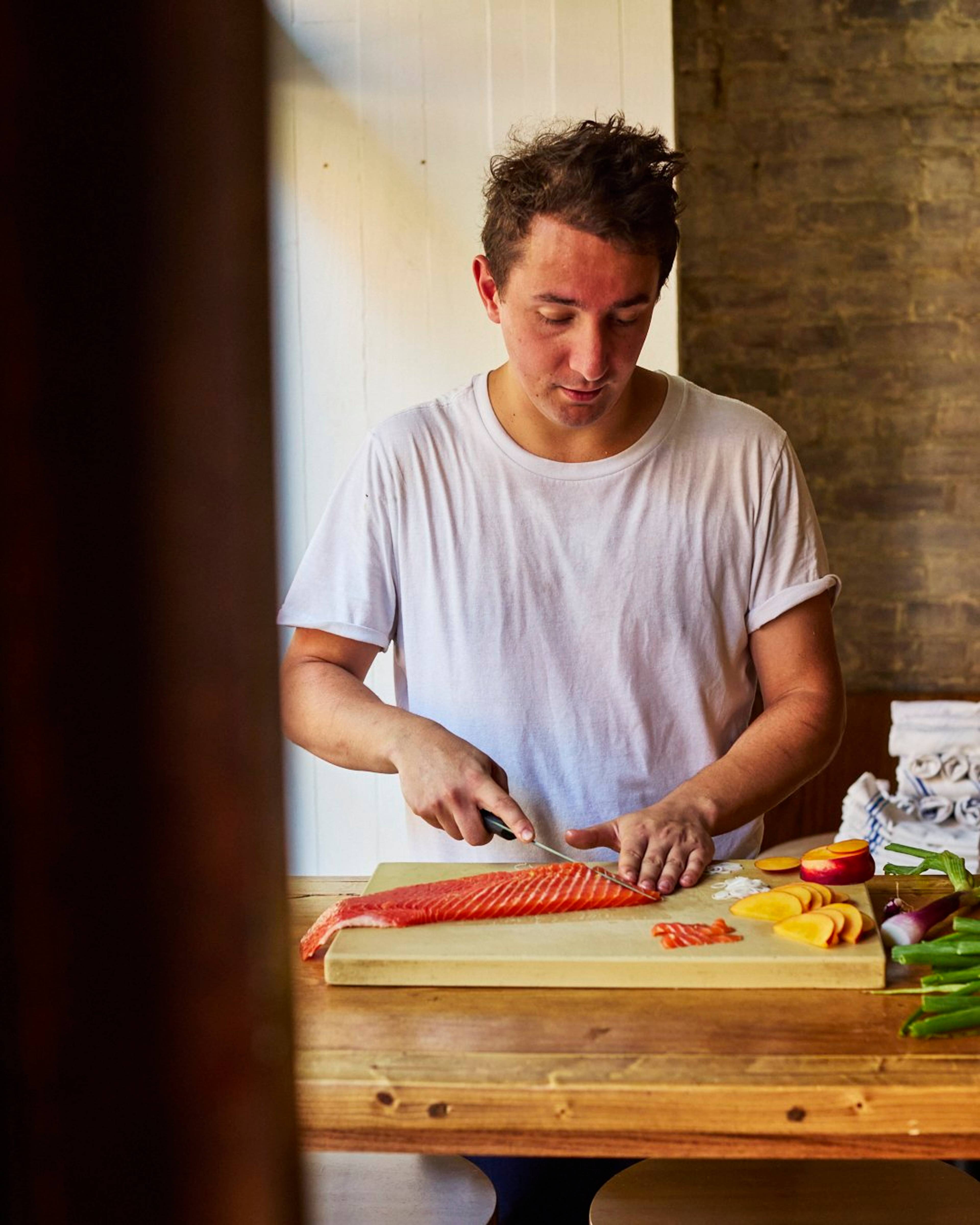 Ed Szymanski slicing trout at Dame restaurant