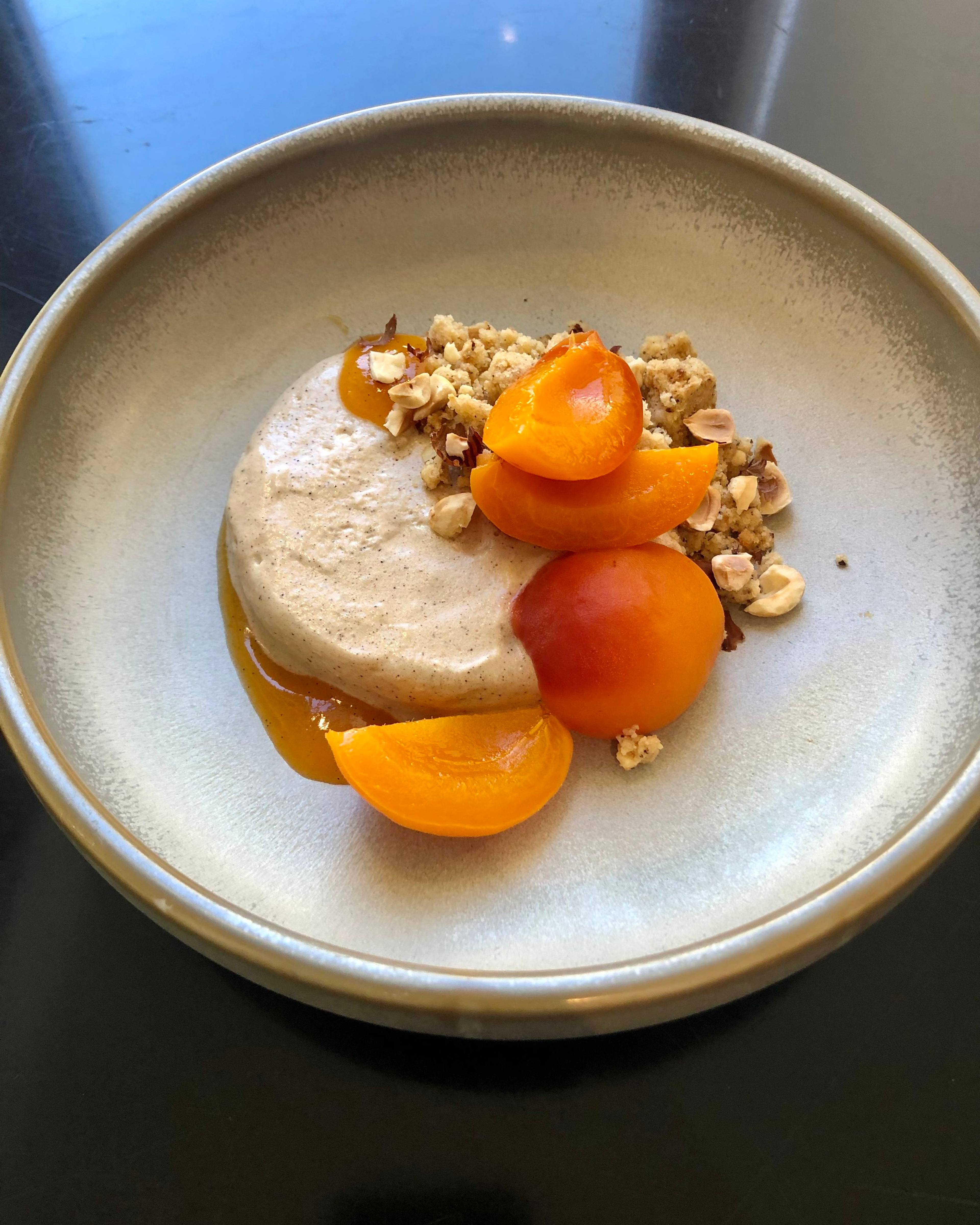 Spiced poached apricots, coffee semifreddo & hazelnut crumble plated