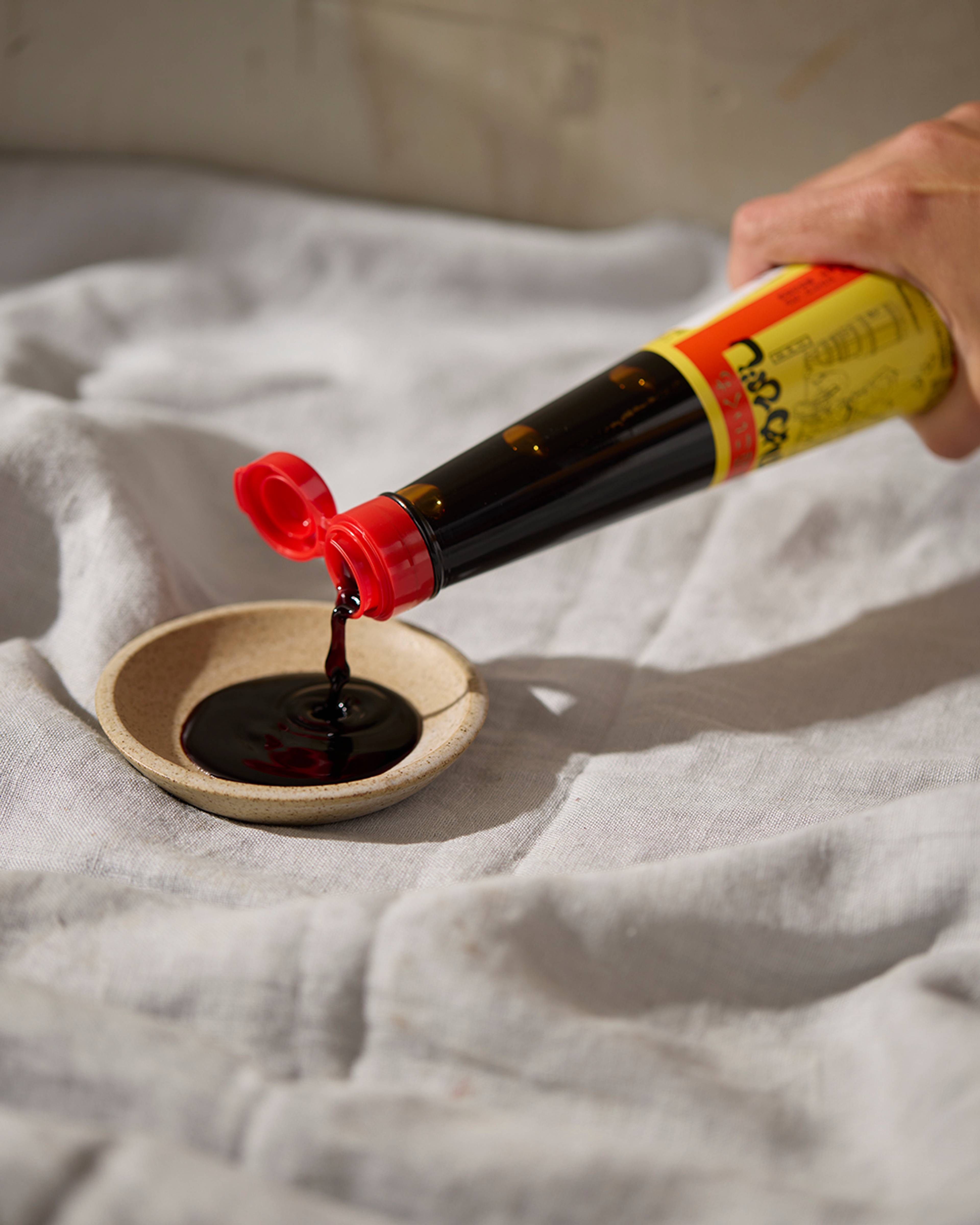 soy sauce being poured into a bowl